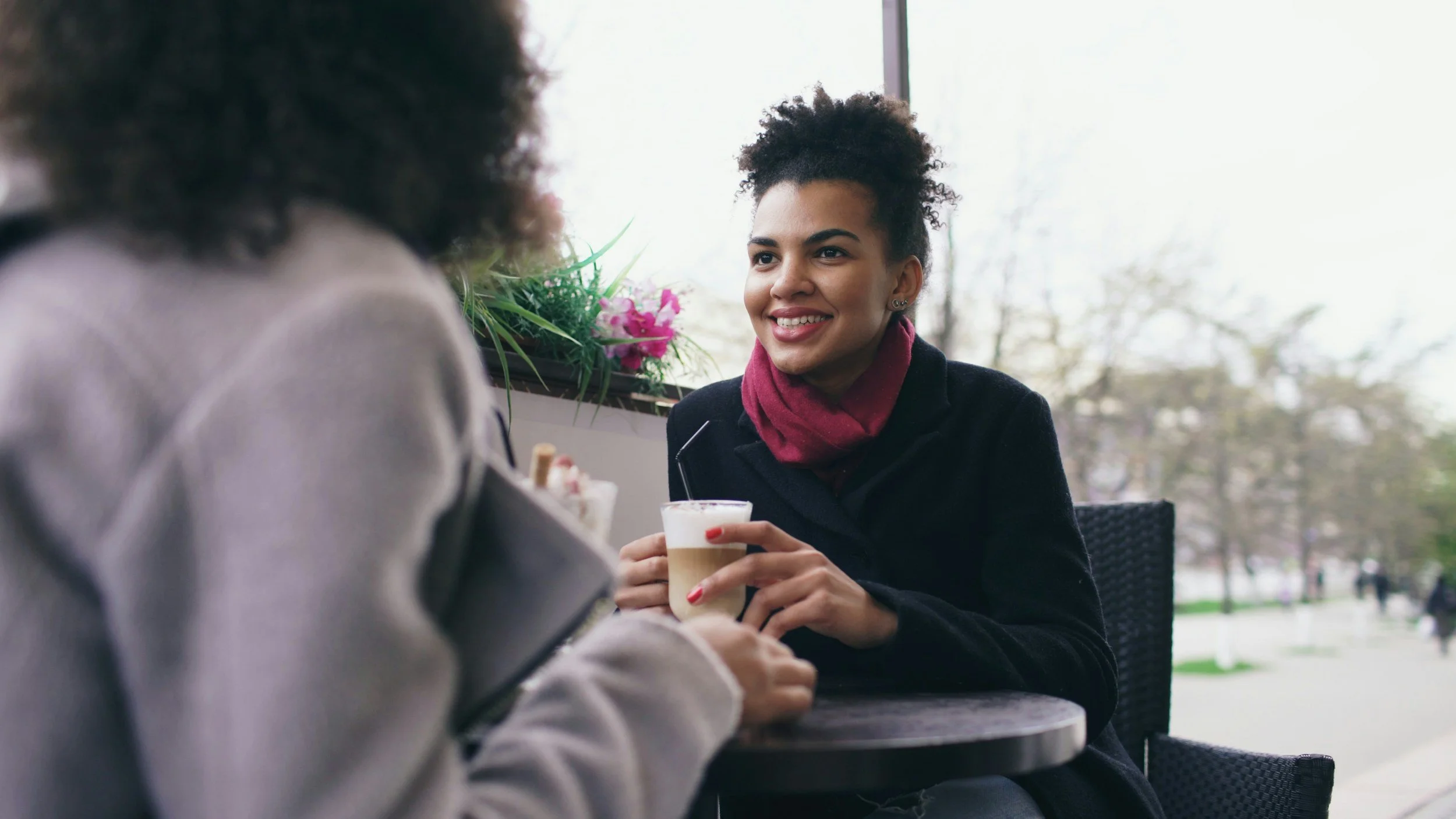 Two women having coffee during coaching session