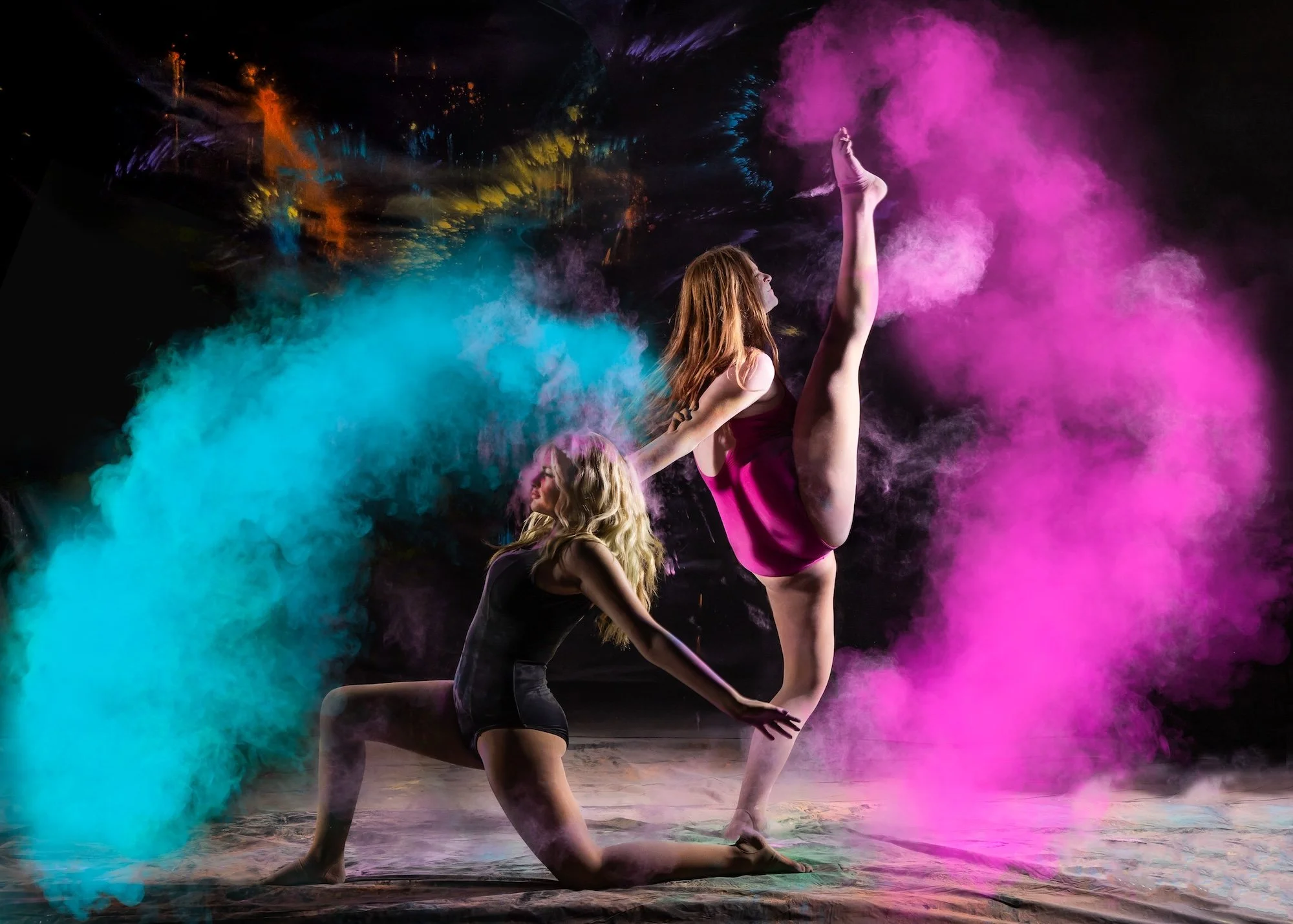 two dancers posing with smoke