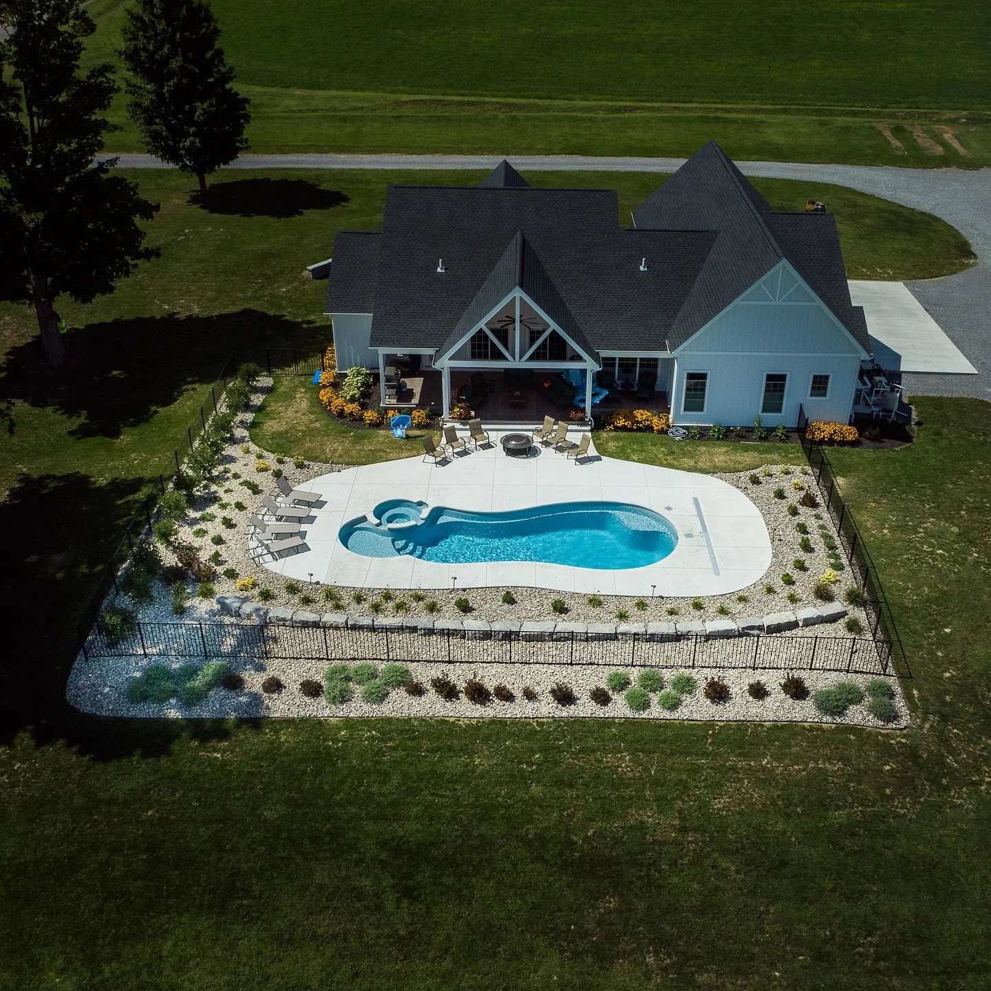 What is a Pool Surround? 
Short answer: It’s the difference between “a pool in a yard” and a backyard that feels like a resort. 
The pool surround is everything that frames your pool: coping, deck/patio surface, steps and transiti