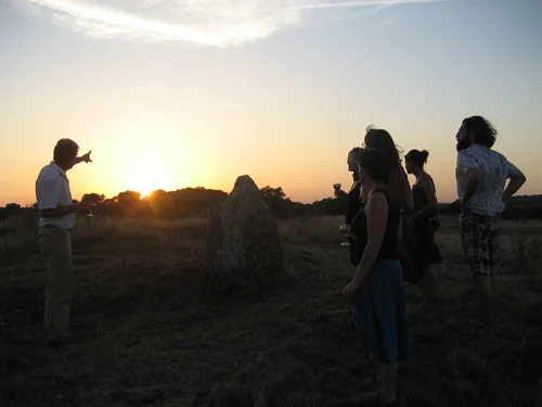 Our host Ludger pointing to the setting sun in line with the Solstice Rock.