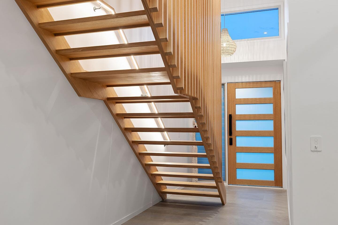 This stunning staircase deserves a little extra lighting. The LED strip hidden under its handrail shows off the natural beauty of the woods character. 

Electrical &bull; @bwelectricalanddata 
Builder &bull; @seachangebuilders