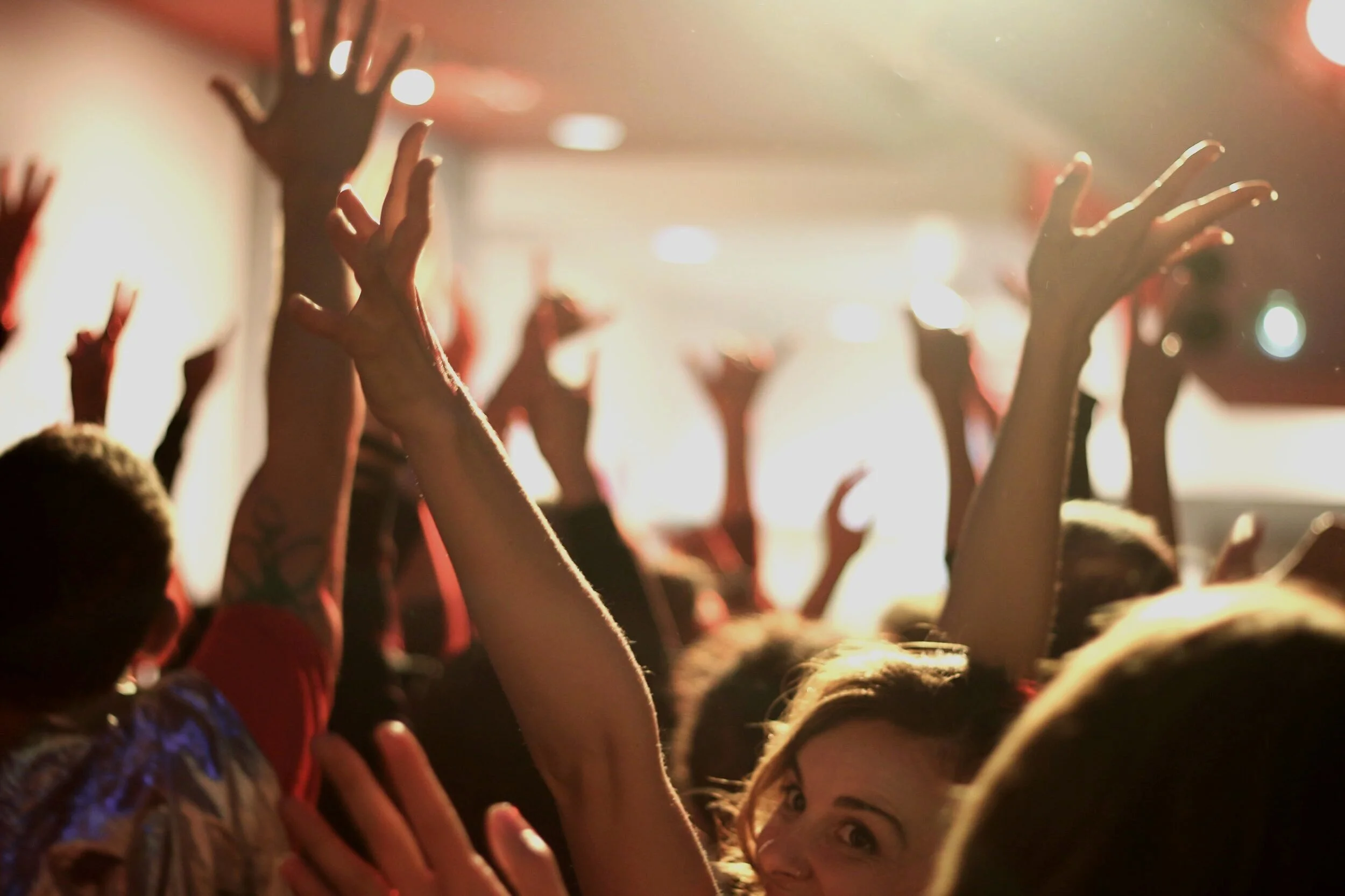 many people with hands in the air
