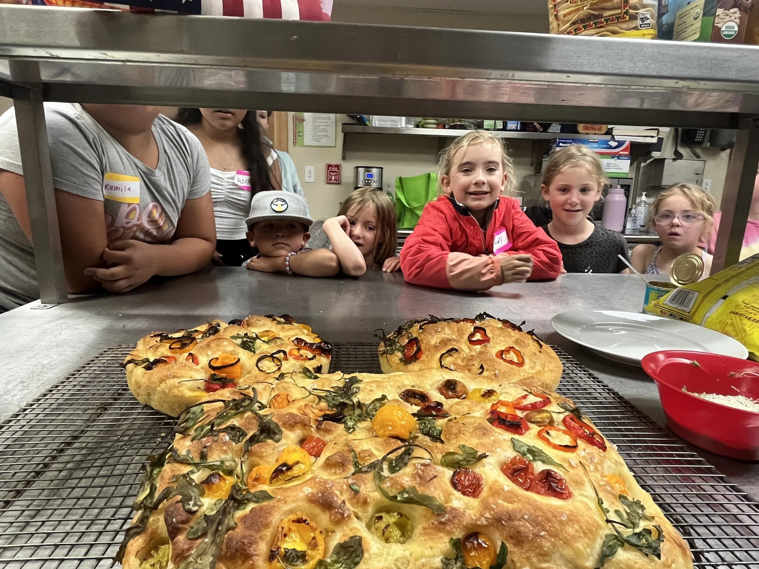 camp kids looking at pizza baking.jpeg