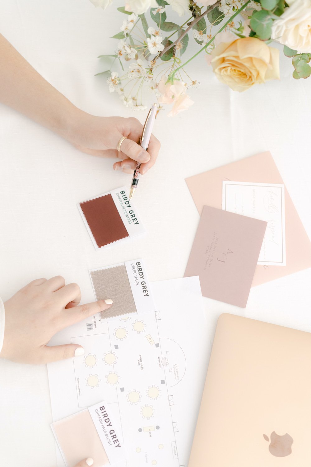 Wedding planner and bride looking at wedding color palette swatches