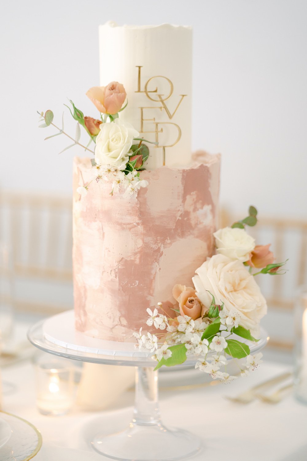 2-tier buttercream watercolor wedding cake  with flowers.