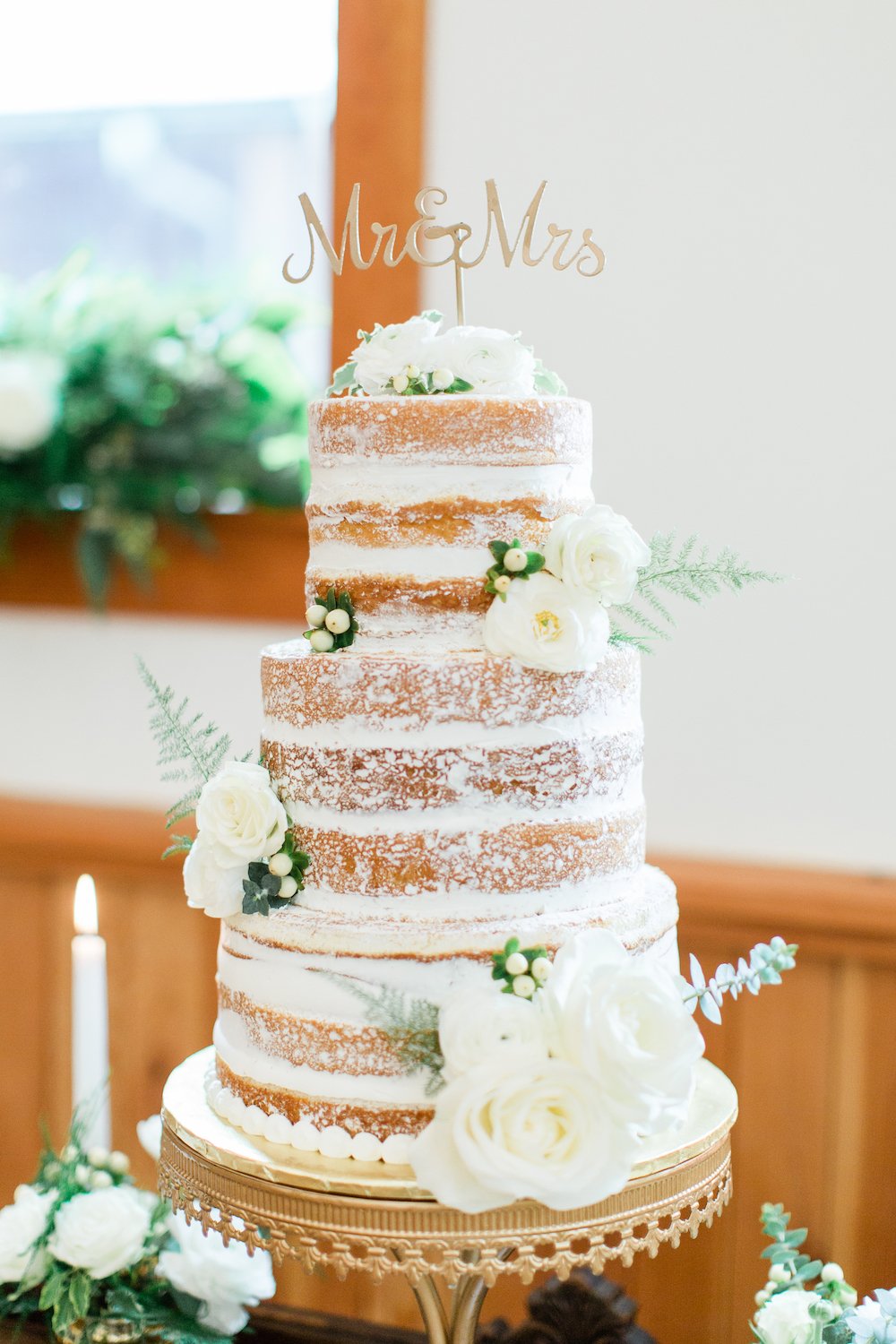 3-tier rustic naked cake with flowers.