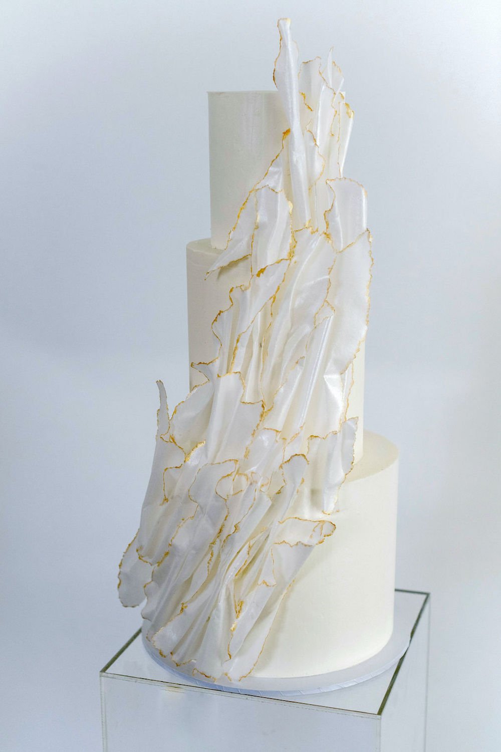 3-tier tall eclectic wedding cake with wafer paper and gold details. 