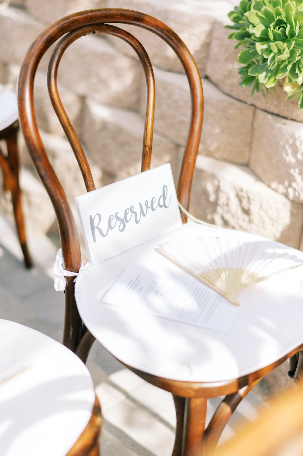 Backyard wedding ceremony reserved seating sign.