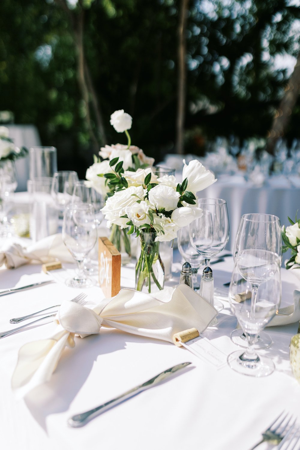 White wedding reception table details and centerpieces.