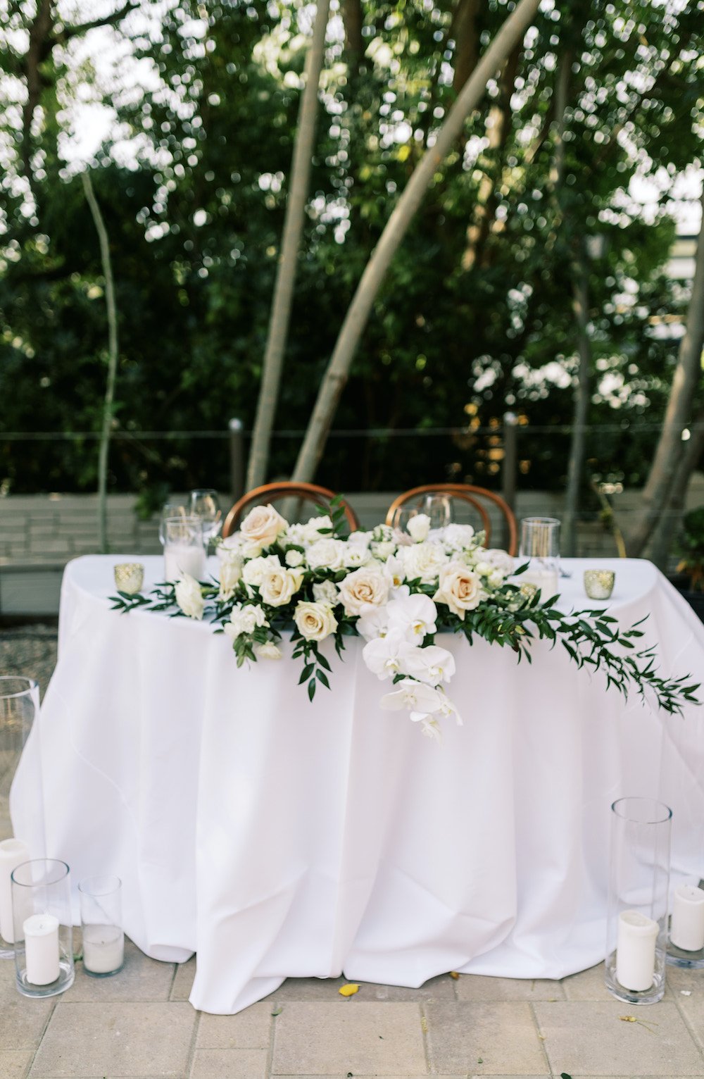 Elegant white summer wedding sweetheart table.