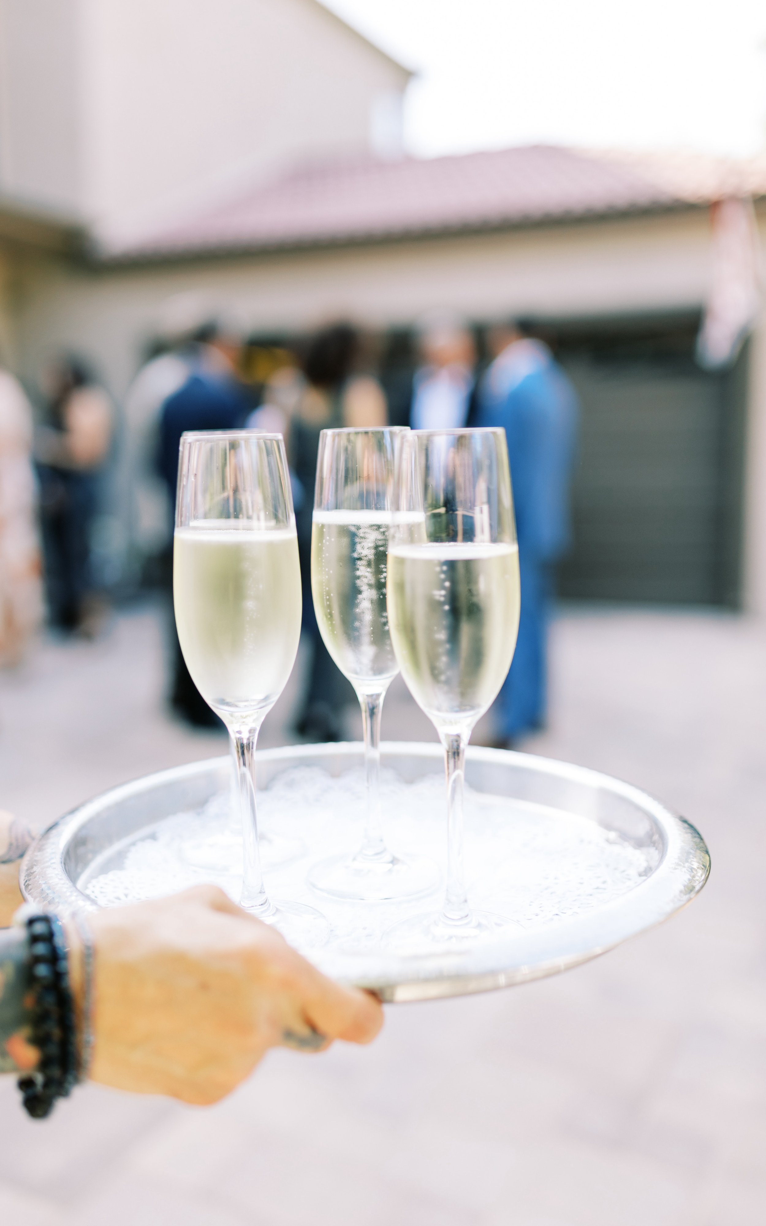Wedding ceremony welcome champagne at this elegant backyard wedding in Los Angeles.