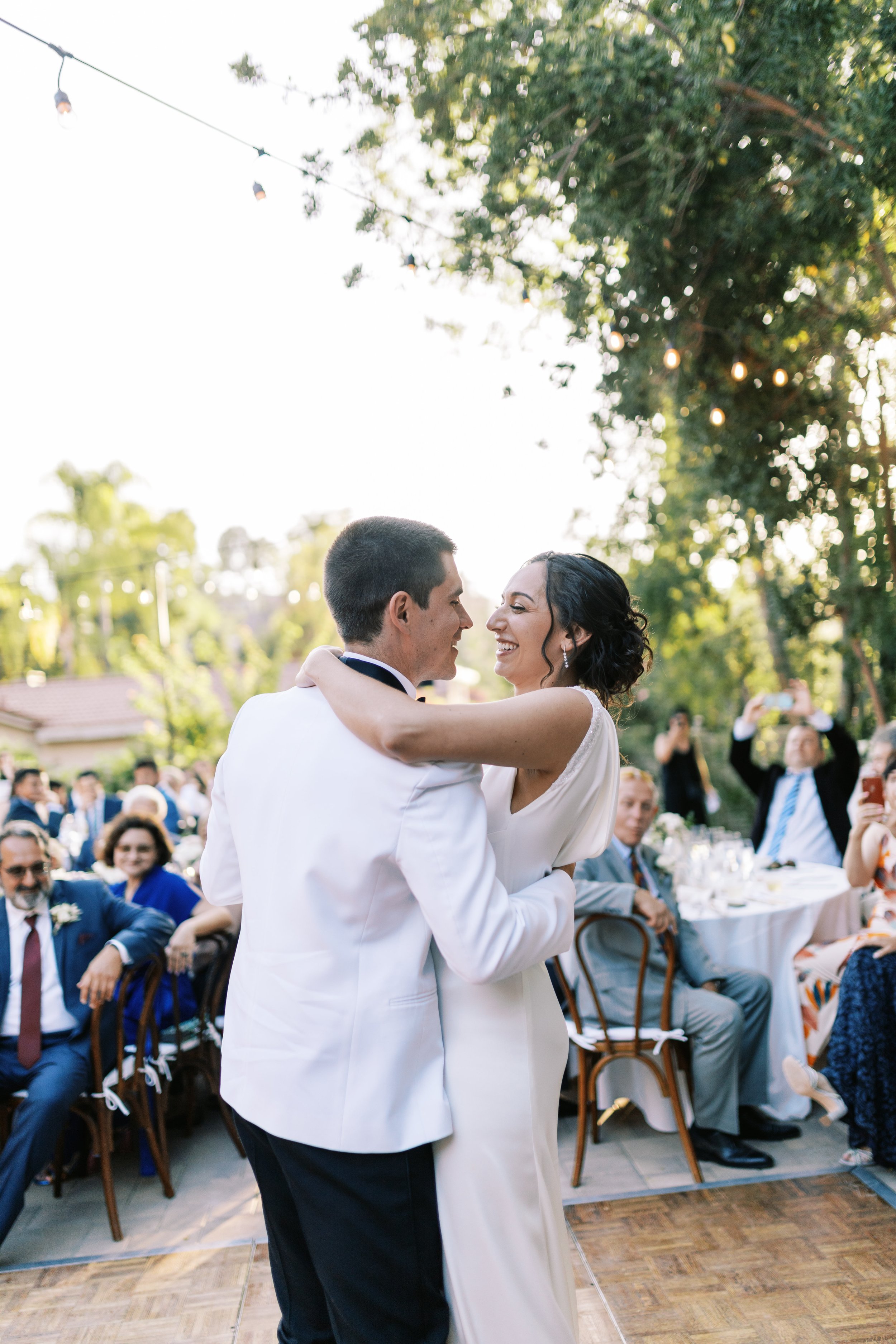 Backyard Los Angeles wedding first dance on a portable wooden dancefloor.