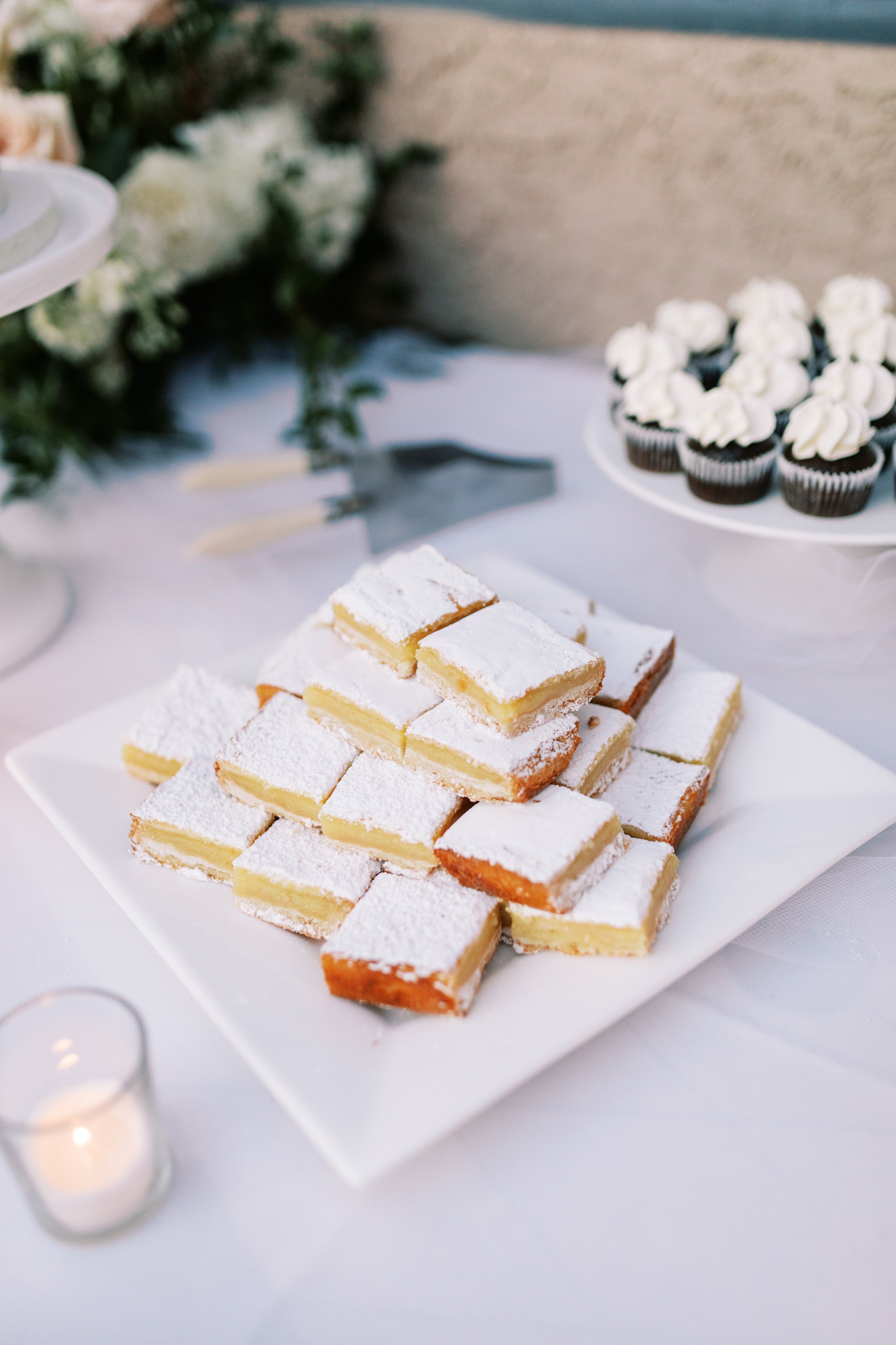 Elegant backyard wedding dessert table lemon bars.