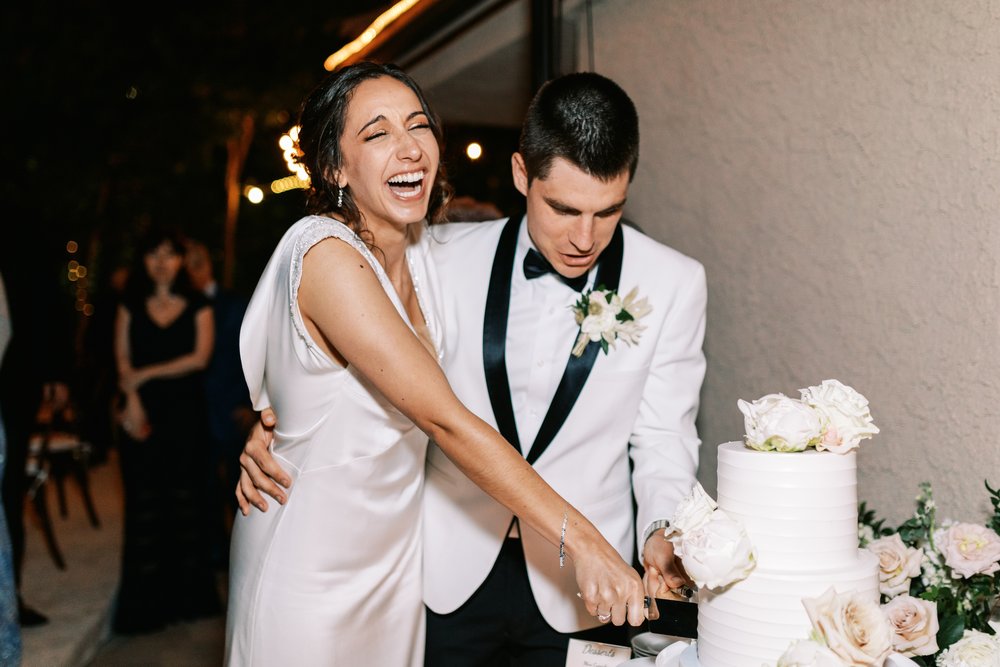 Los Angeles backyard wedding reception cake cutting. 