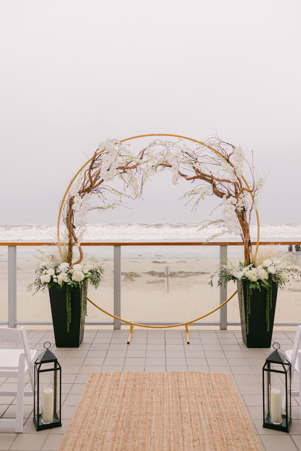 Modern circle arch wedding ceremony backdrop at Malibu West Beach Club.