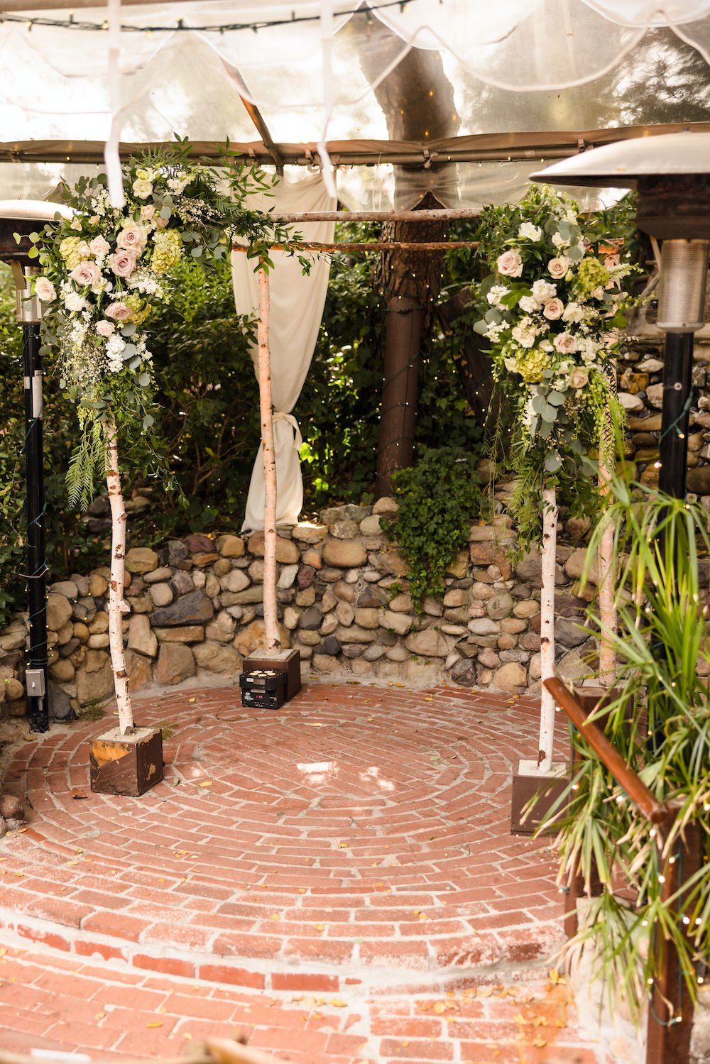 Rustic wedding ceremony arch at the Inn at Seventh Ray in Los Angeles.