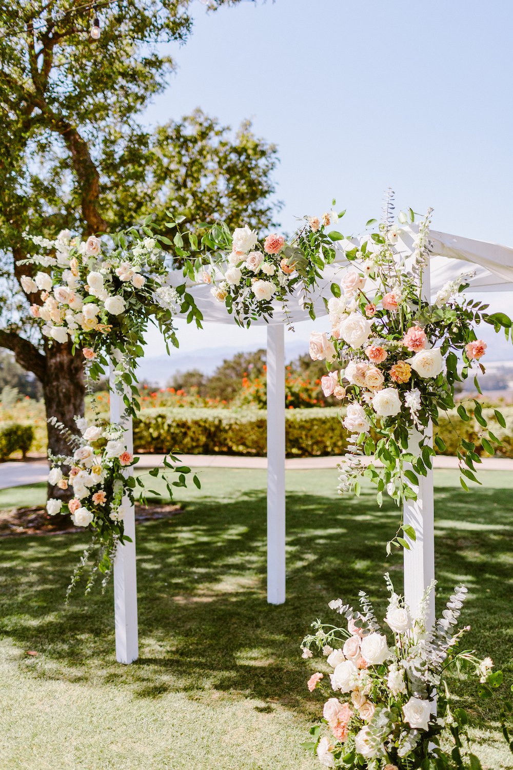 Garden wedding ceremony chuppah with flowers at the Spanish Hills Country Club in Los Angeles.