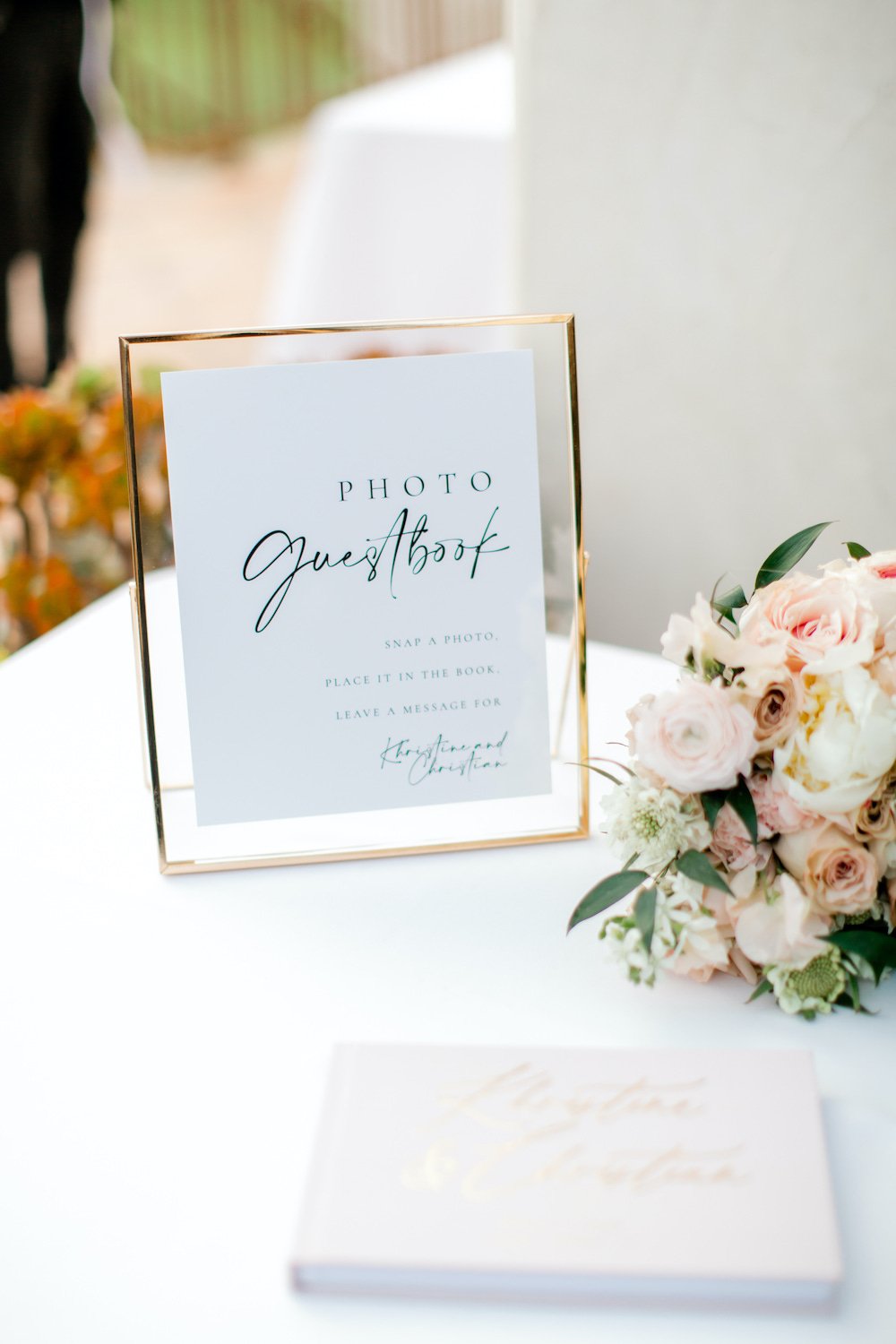 Photo guestbook sign in a gold frame.