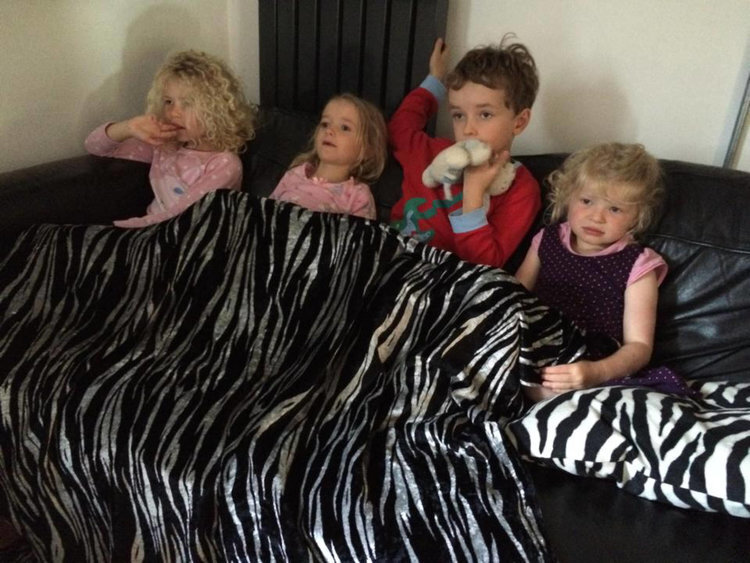 family children under zebra rug.jpg