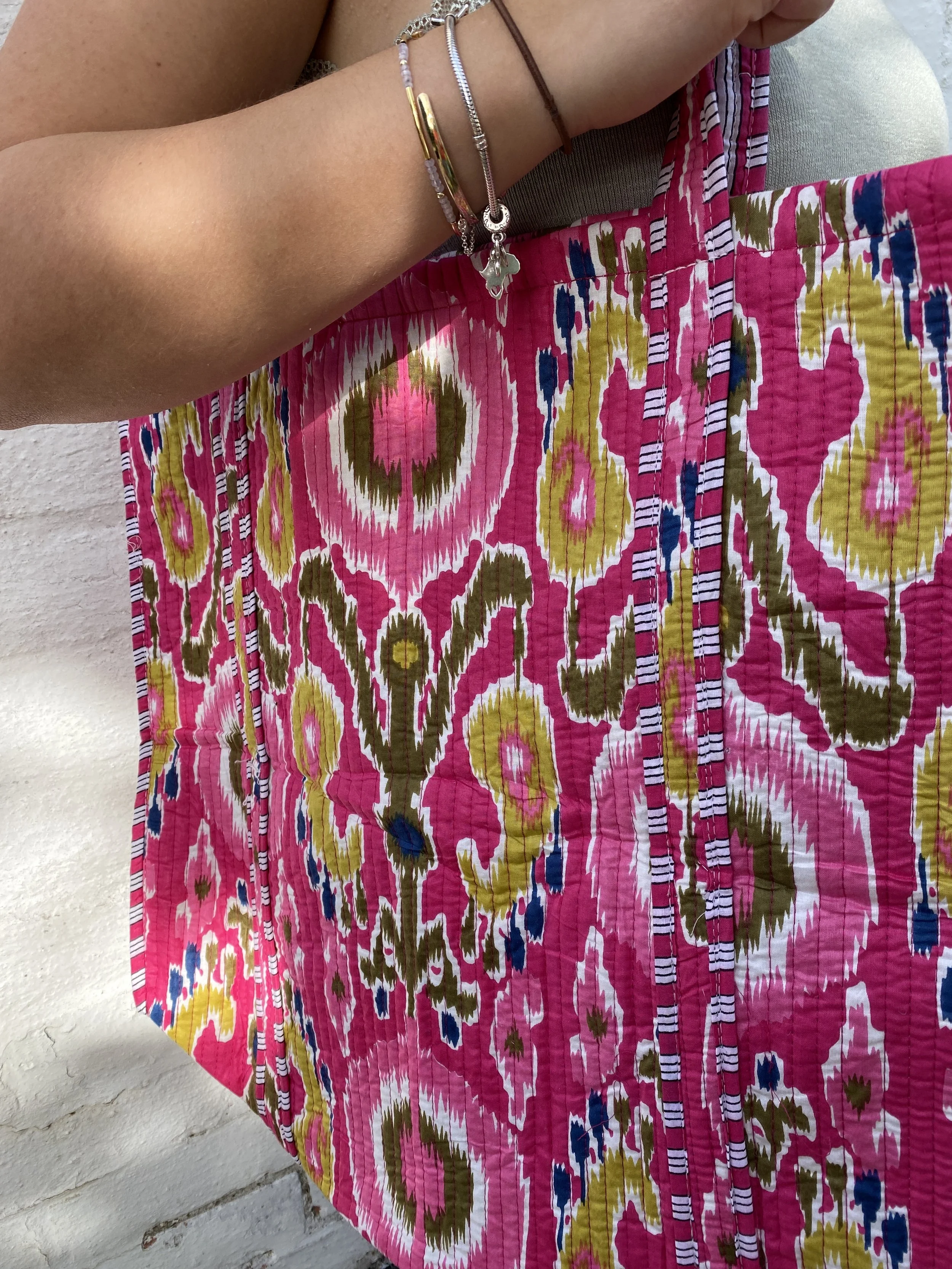 model using a quilted pink fabric tote bag