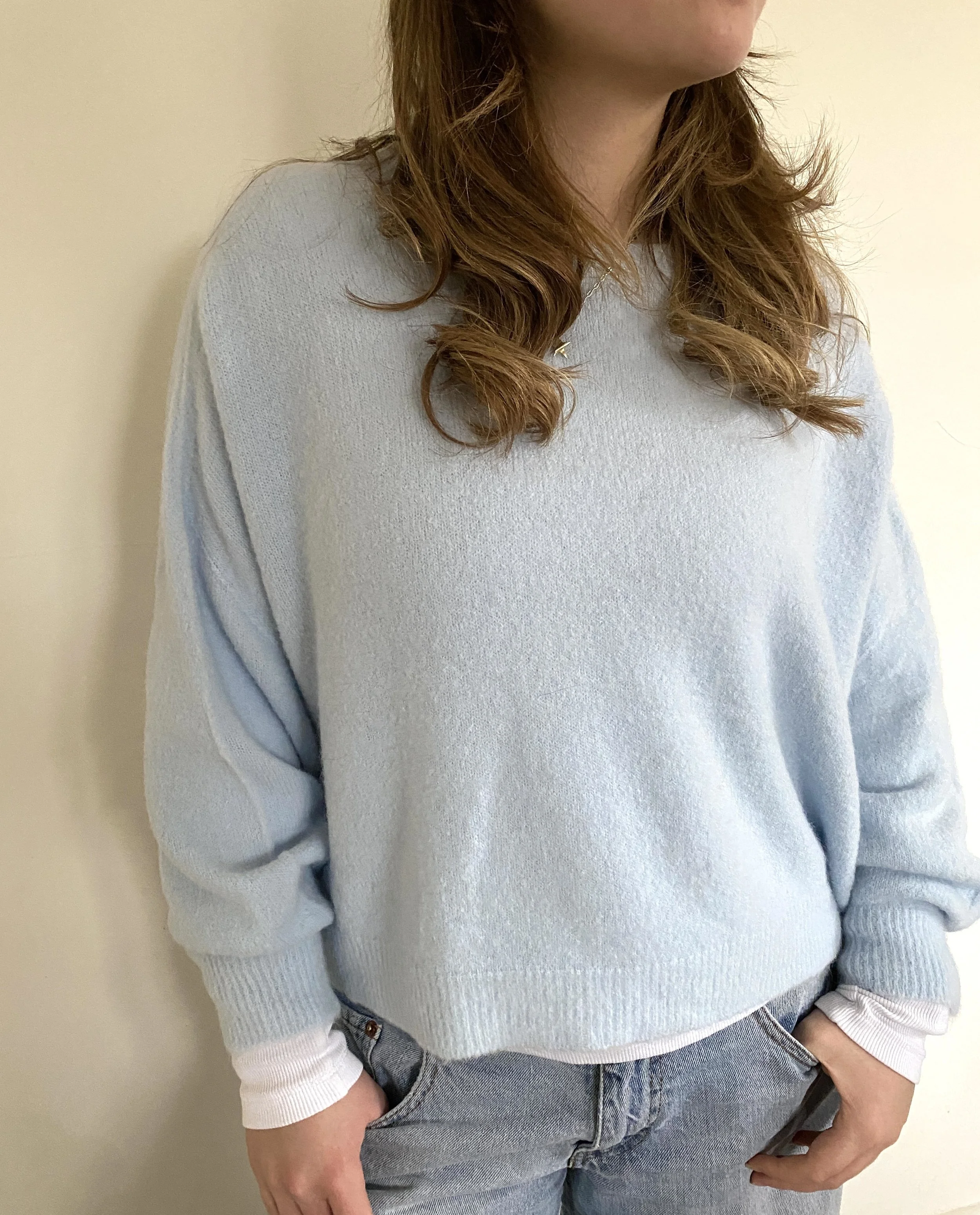 Model wearing pale blue jumper