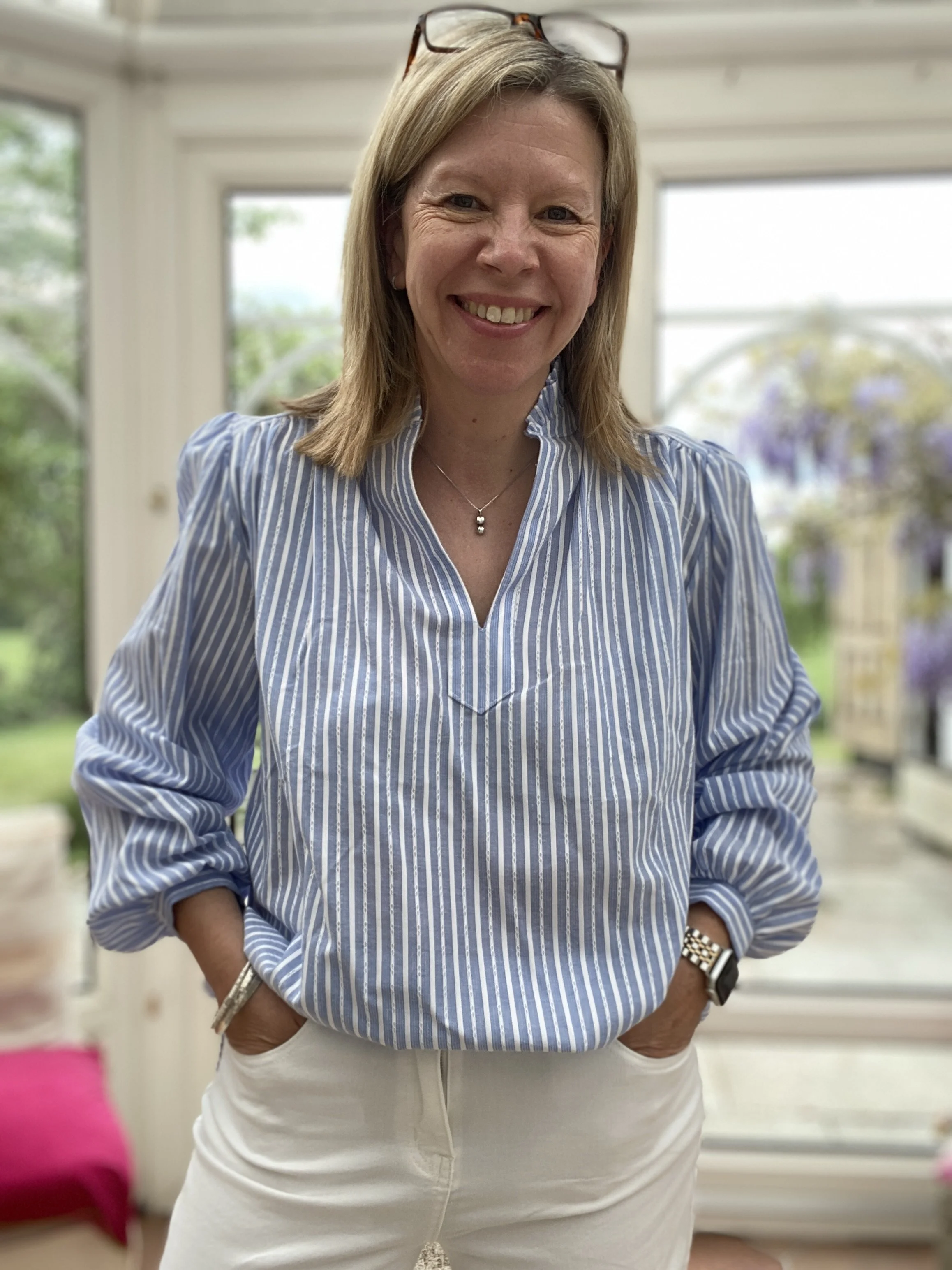 blue and white stripe cotton shirt being worn with white jeans