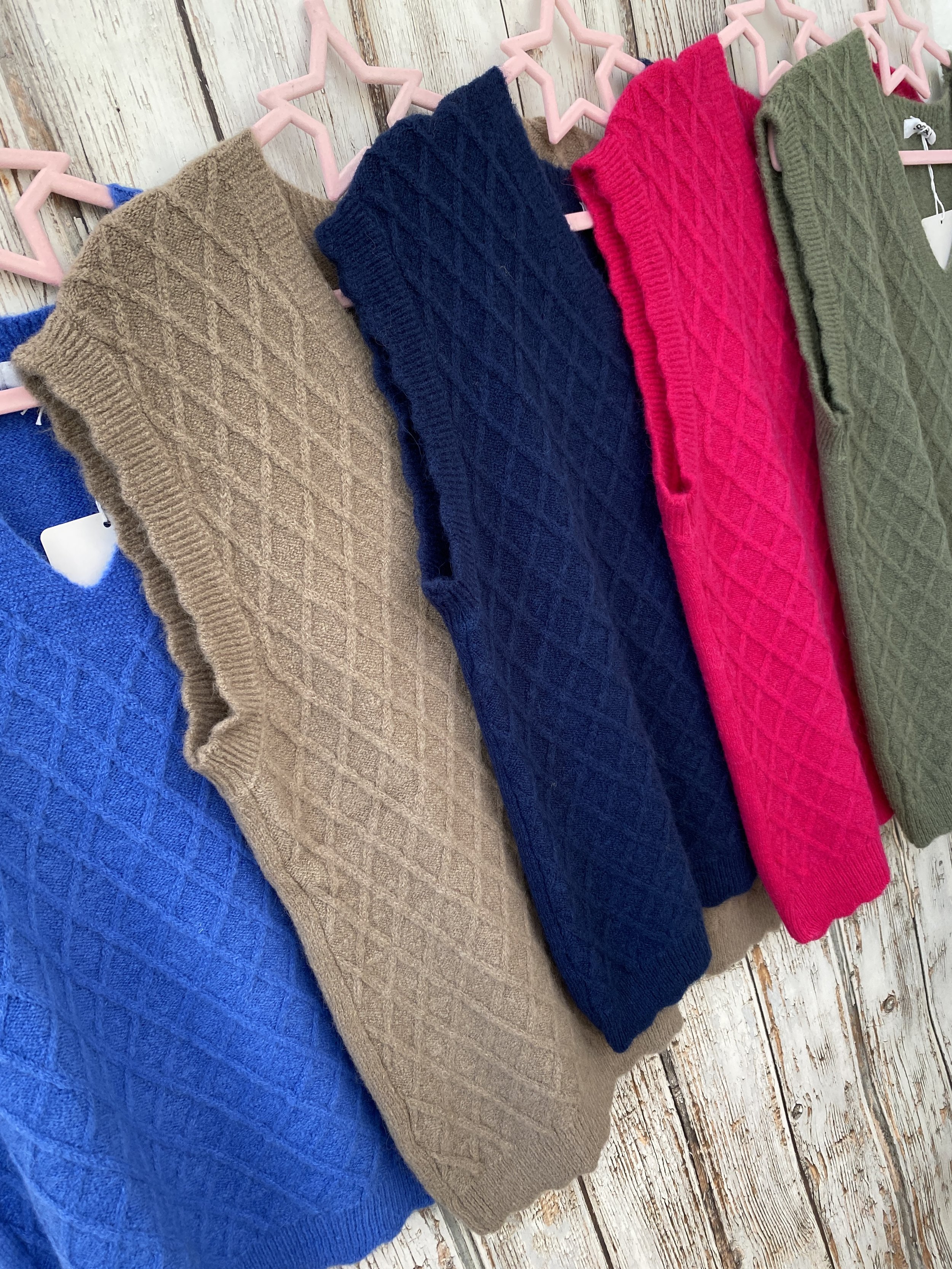 different colour sleeveless jumpers
