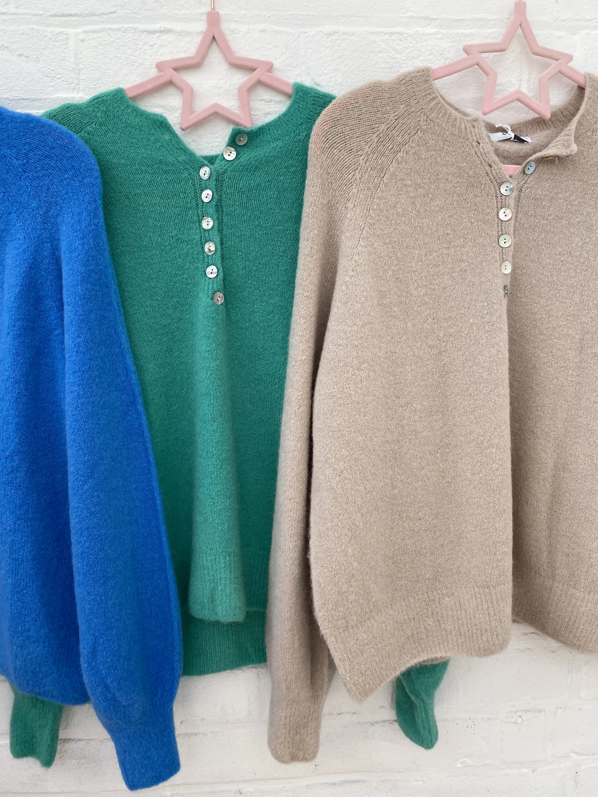Blue, green and beige jumpers
