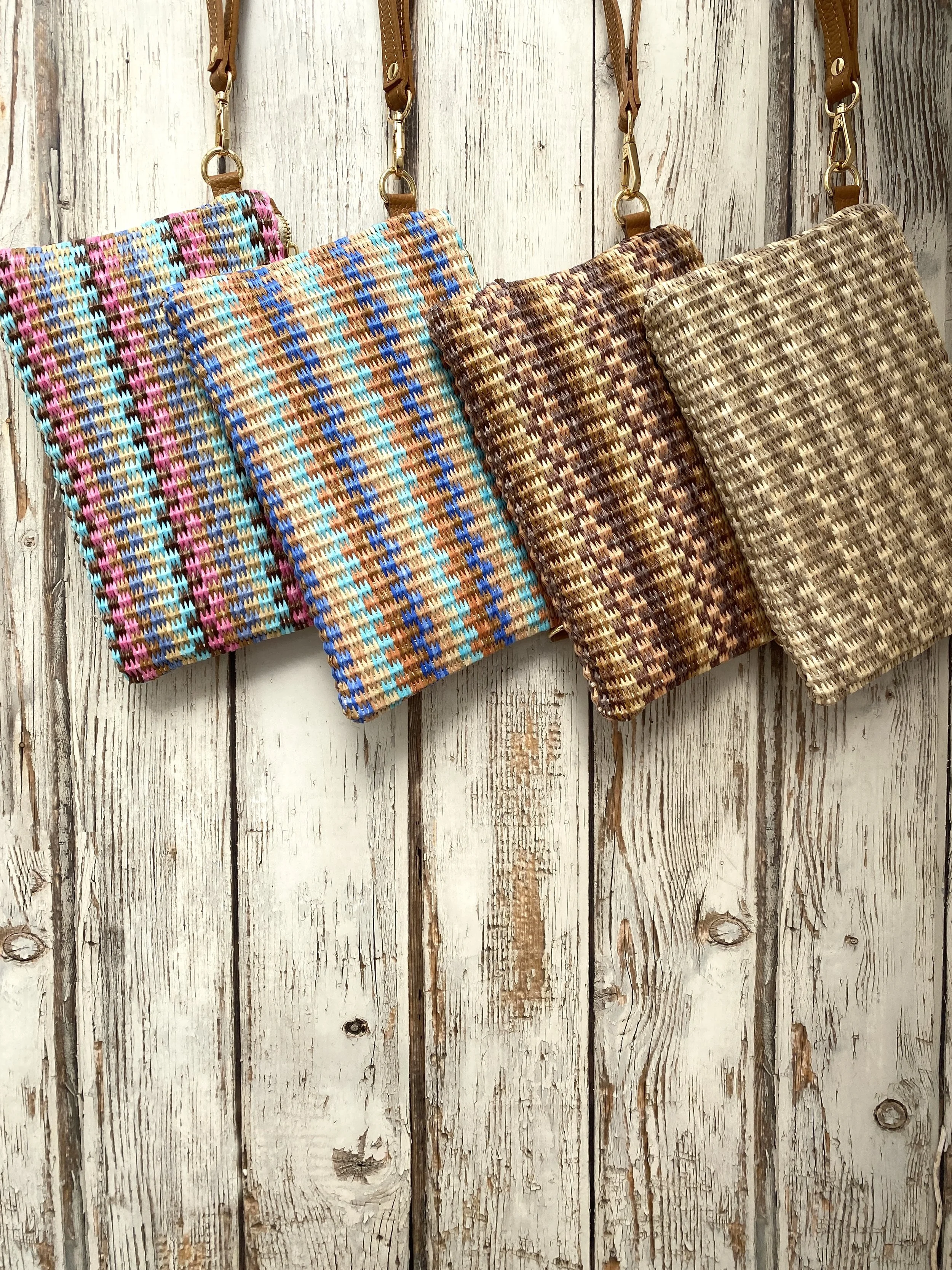 4 raffia handbags on a wooden wall