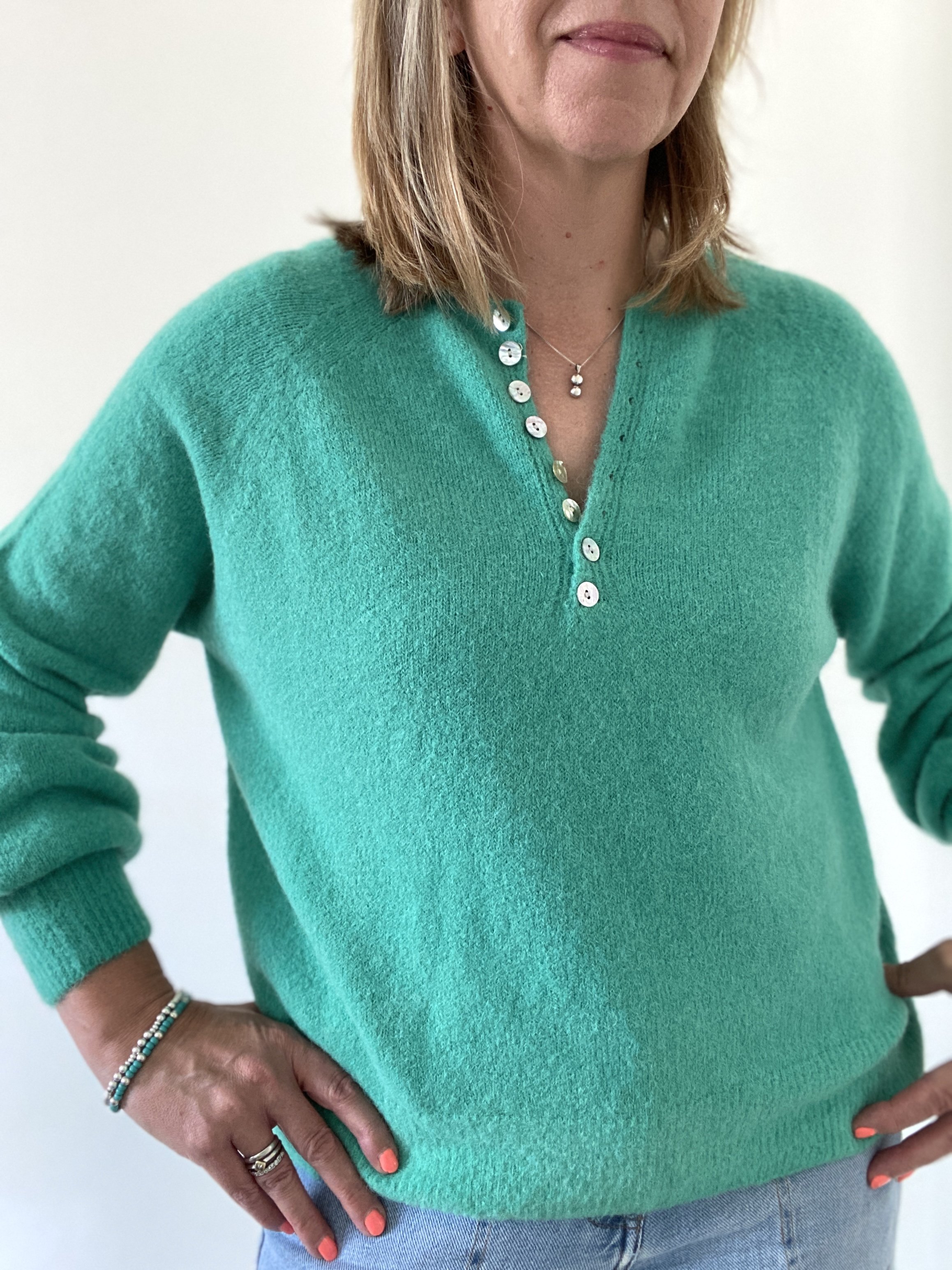 Shamrock green button front jumper being worn
