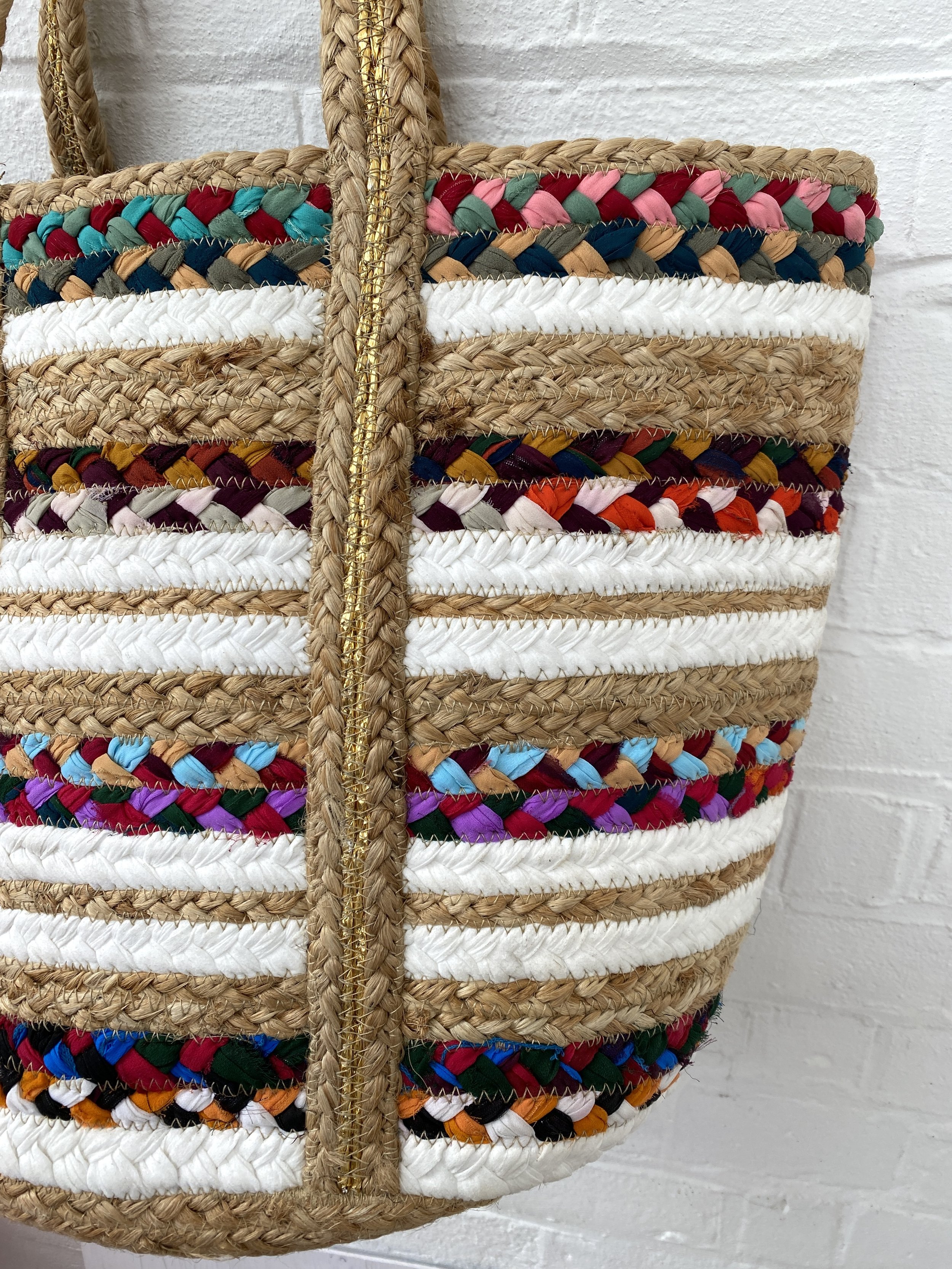 close up of jute basket bag with stripe design