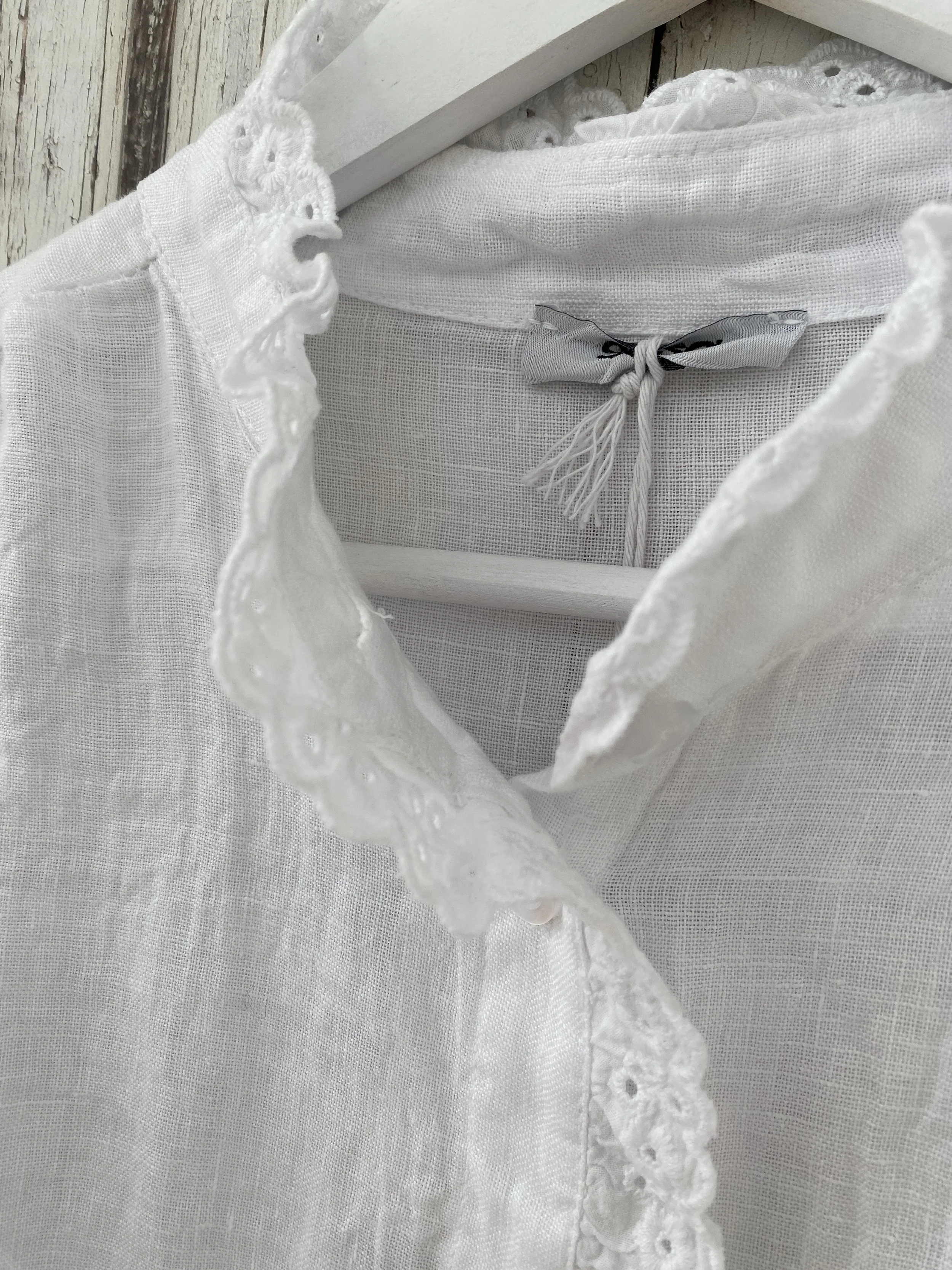 frill edge detail on white linen shirt