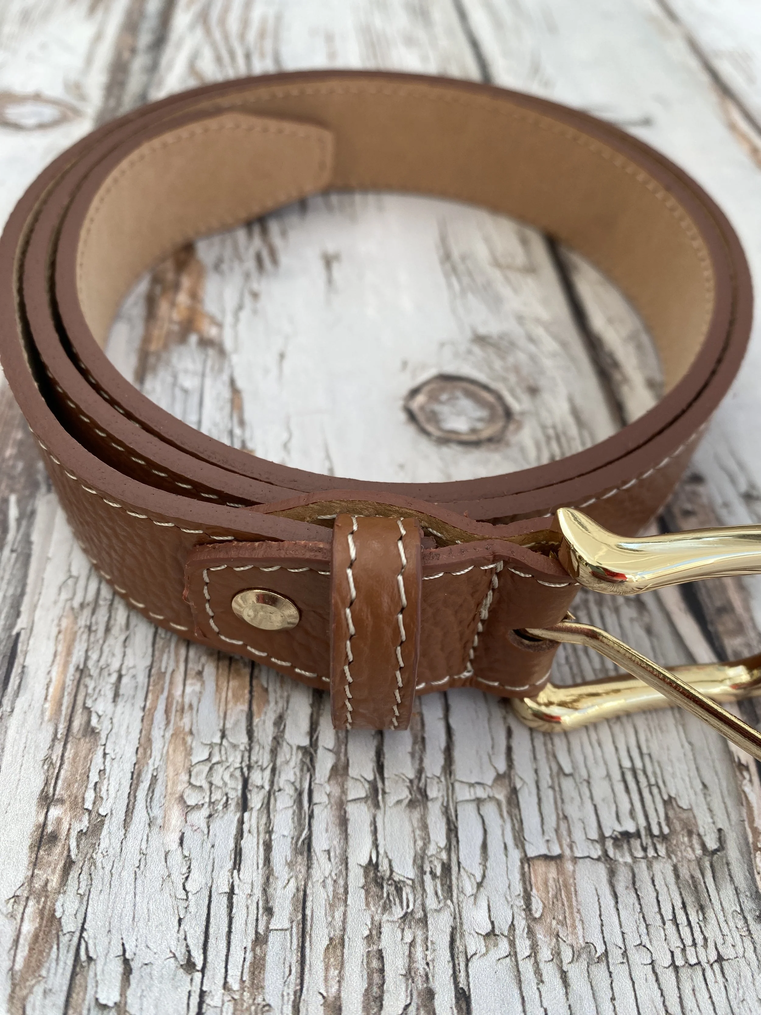 tan leather belt with gold buckle