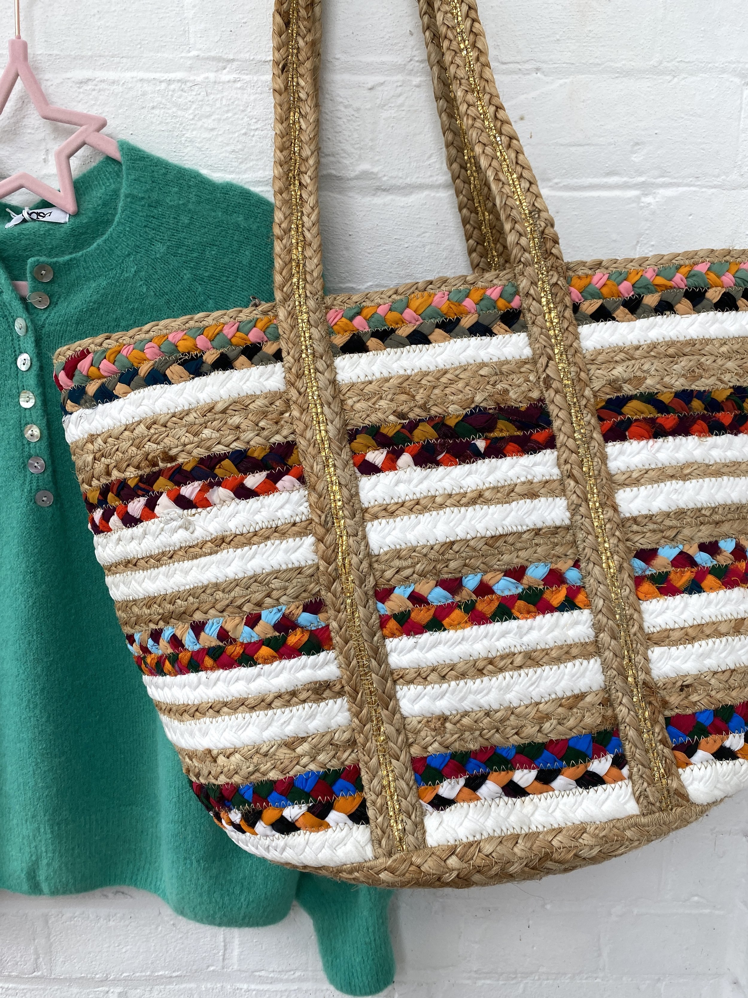 green jumper with jute basket bag accessory