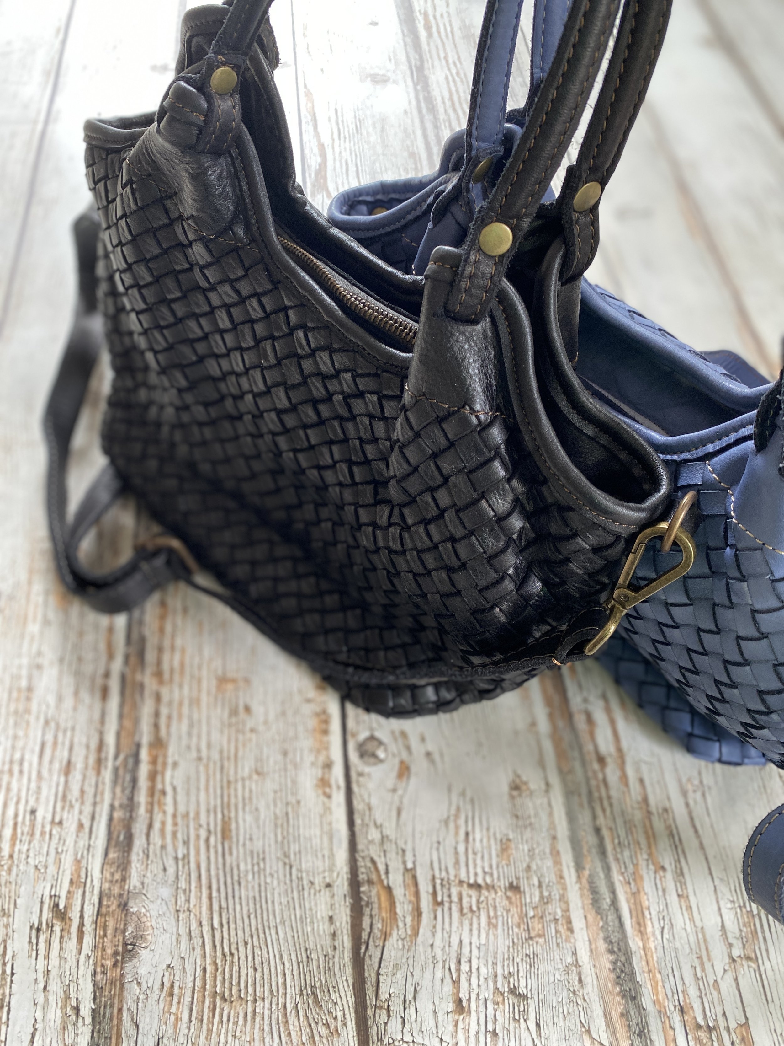 Black woven leather tote with a blue leather tote bag