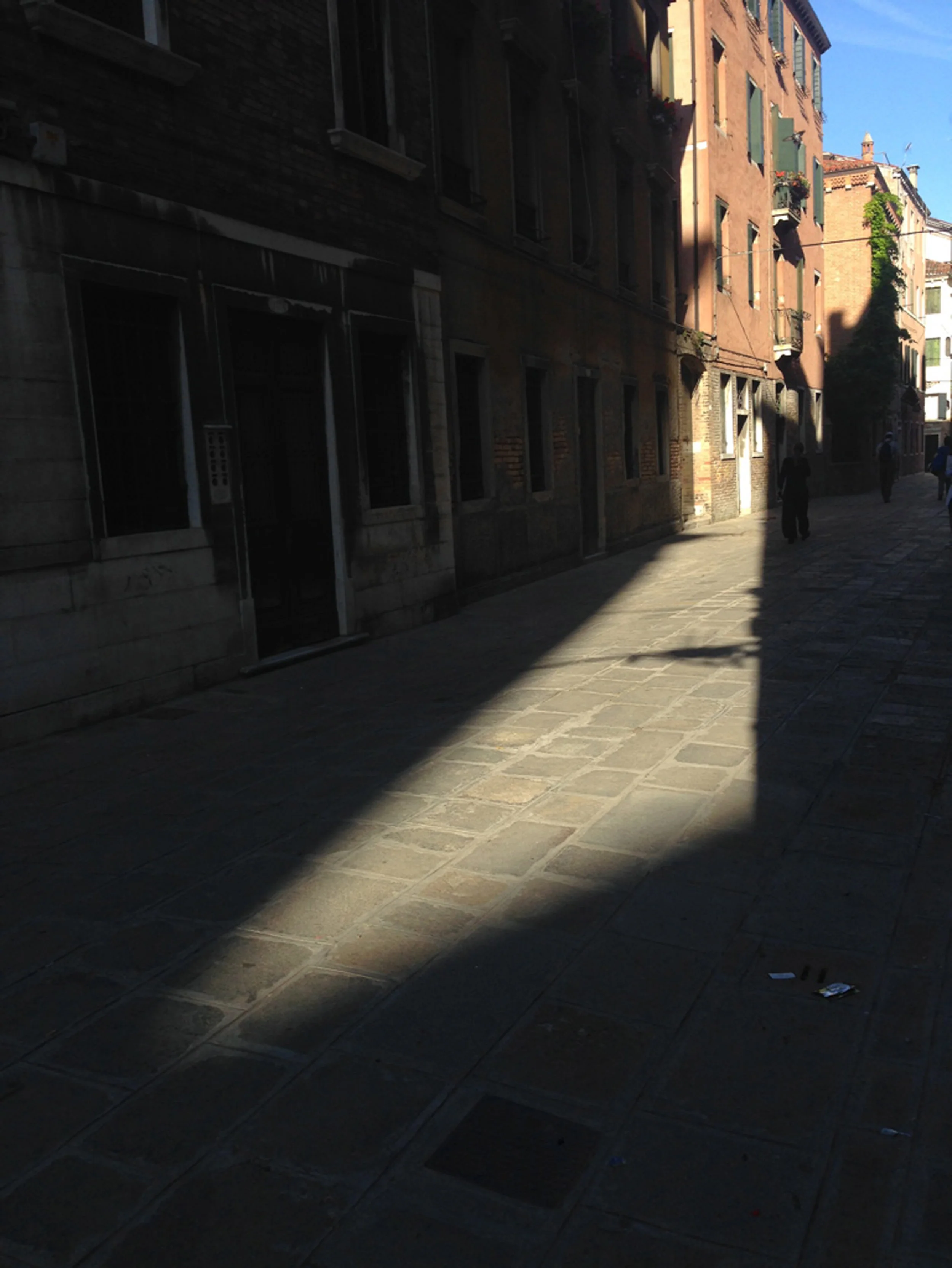Light and shade - street between buildings - buildings cast shadow