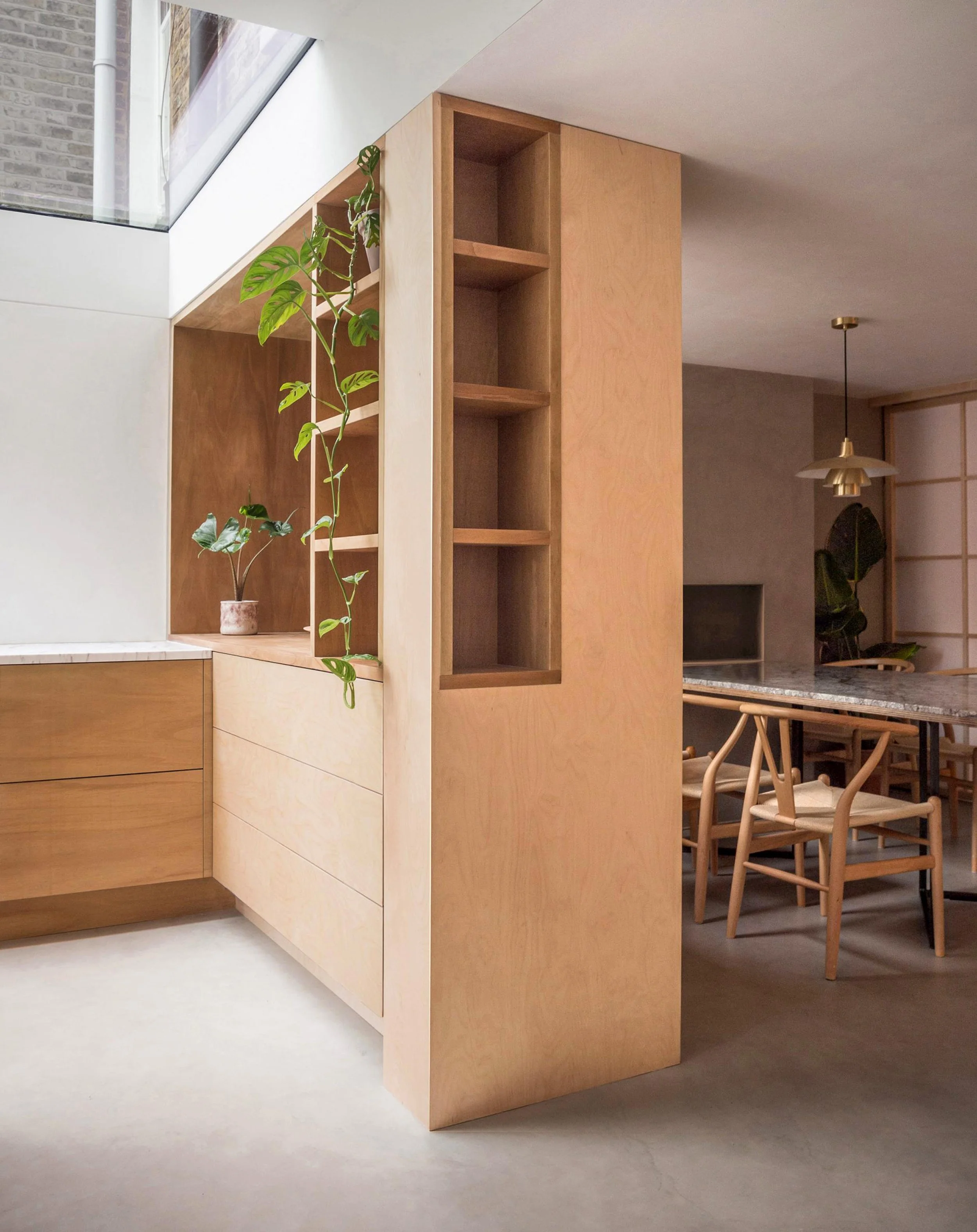 Wooden decor with shelves and greenery in a modern indoor space.