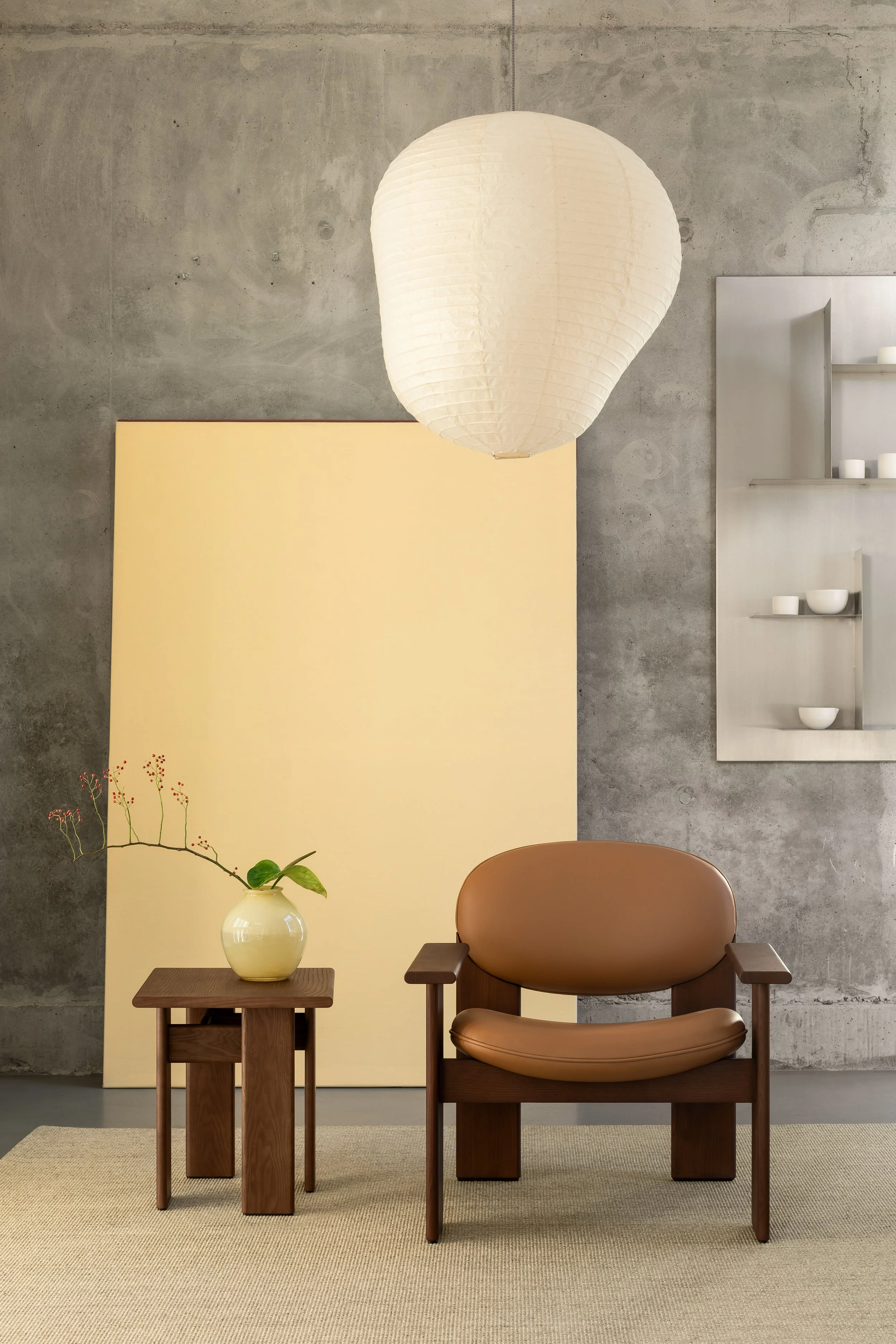 NOOM’s sculptural lounge chairs shown in a range of upholstery and wood tones. Perfect as accent seating in living rooms, offices, and boutique hotels.