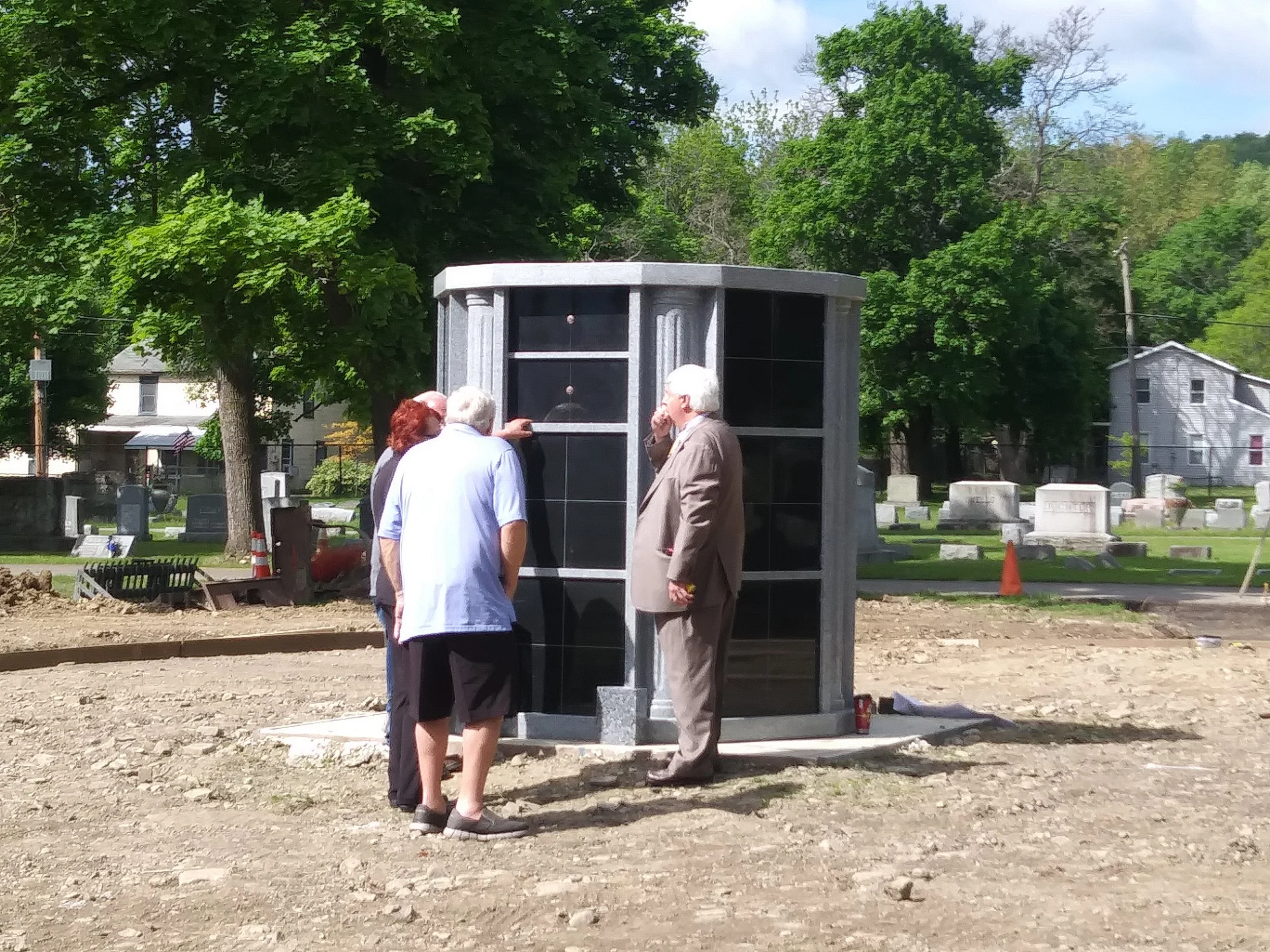 May 24th, the first placement of ashes in the Columbarium. The ashes are those of the Baynes Family, Walter, Helen and son, Christopher. Pictured are Winifred Baynes Burnham, husband Daniel Burnham and Funeral Director Jim Lynch from Lynch's Funeral Home.