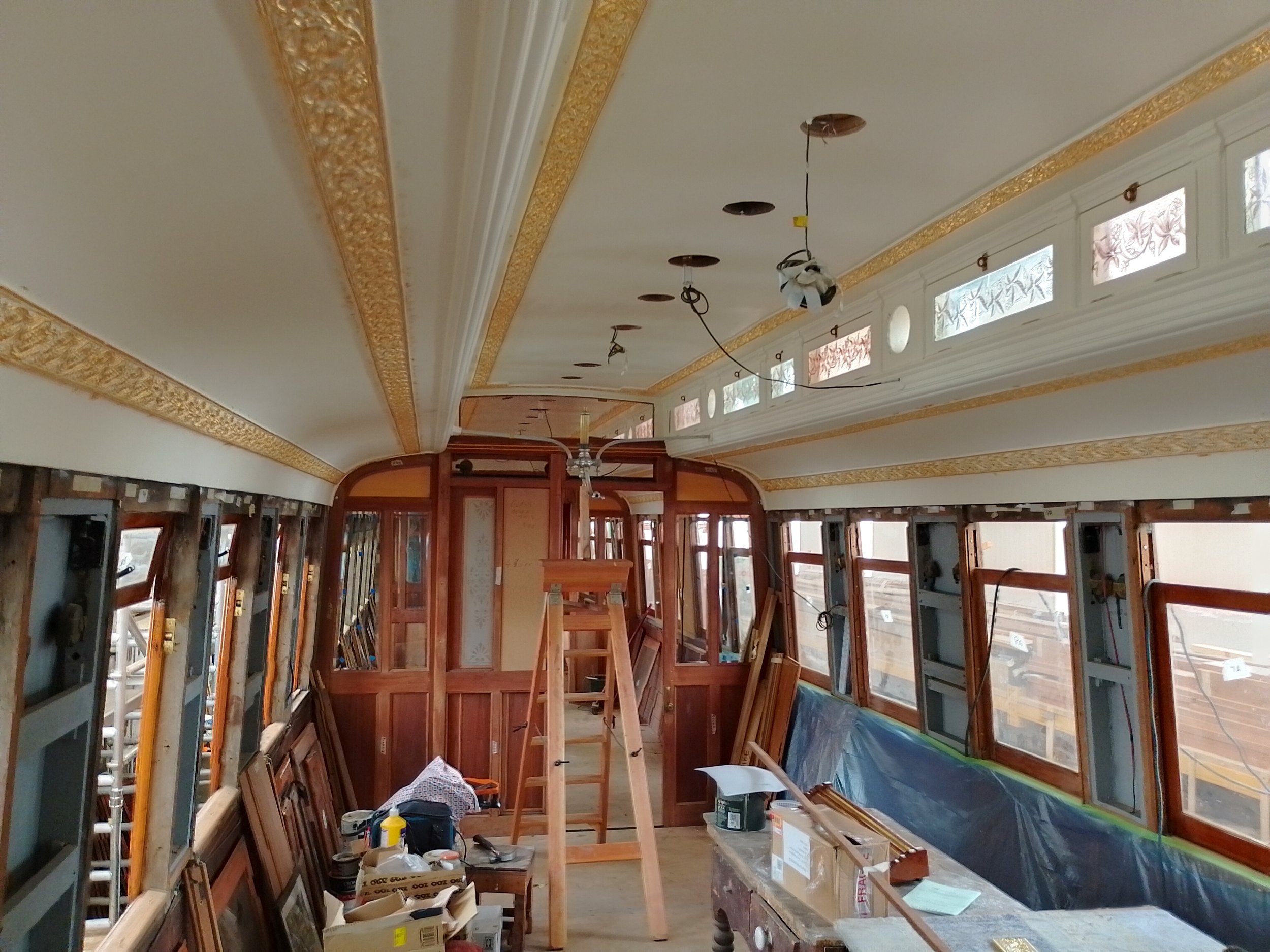 Inside of ECJS 189 showing the re-engineered gasolier light fitting and the gilded Lincrusta border.