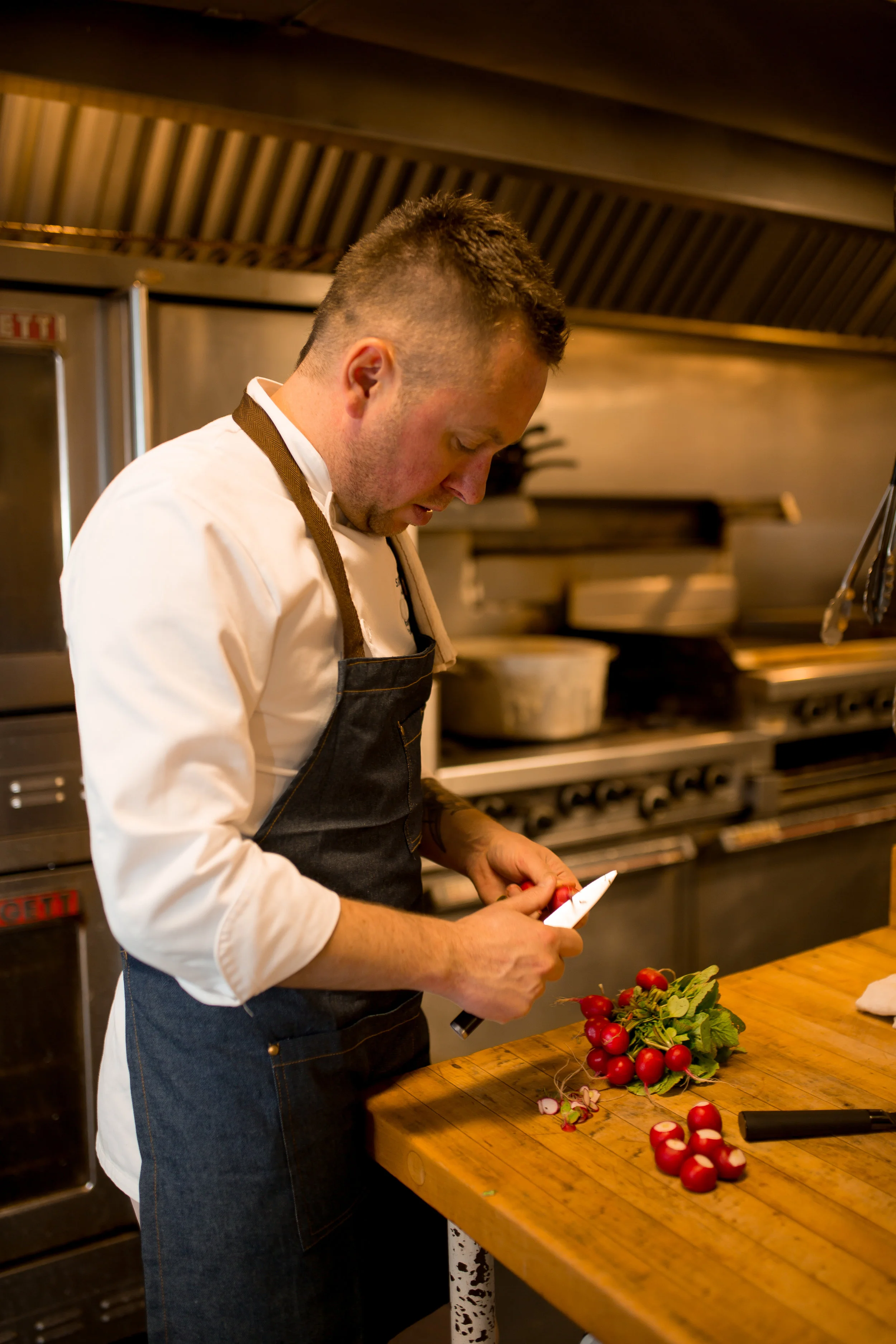 Randy Felker, Executive Chef at Saugeen Golf Club , prepares fresh radishes from Hi-Berry Farm