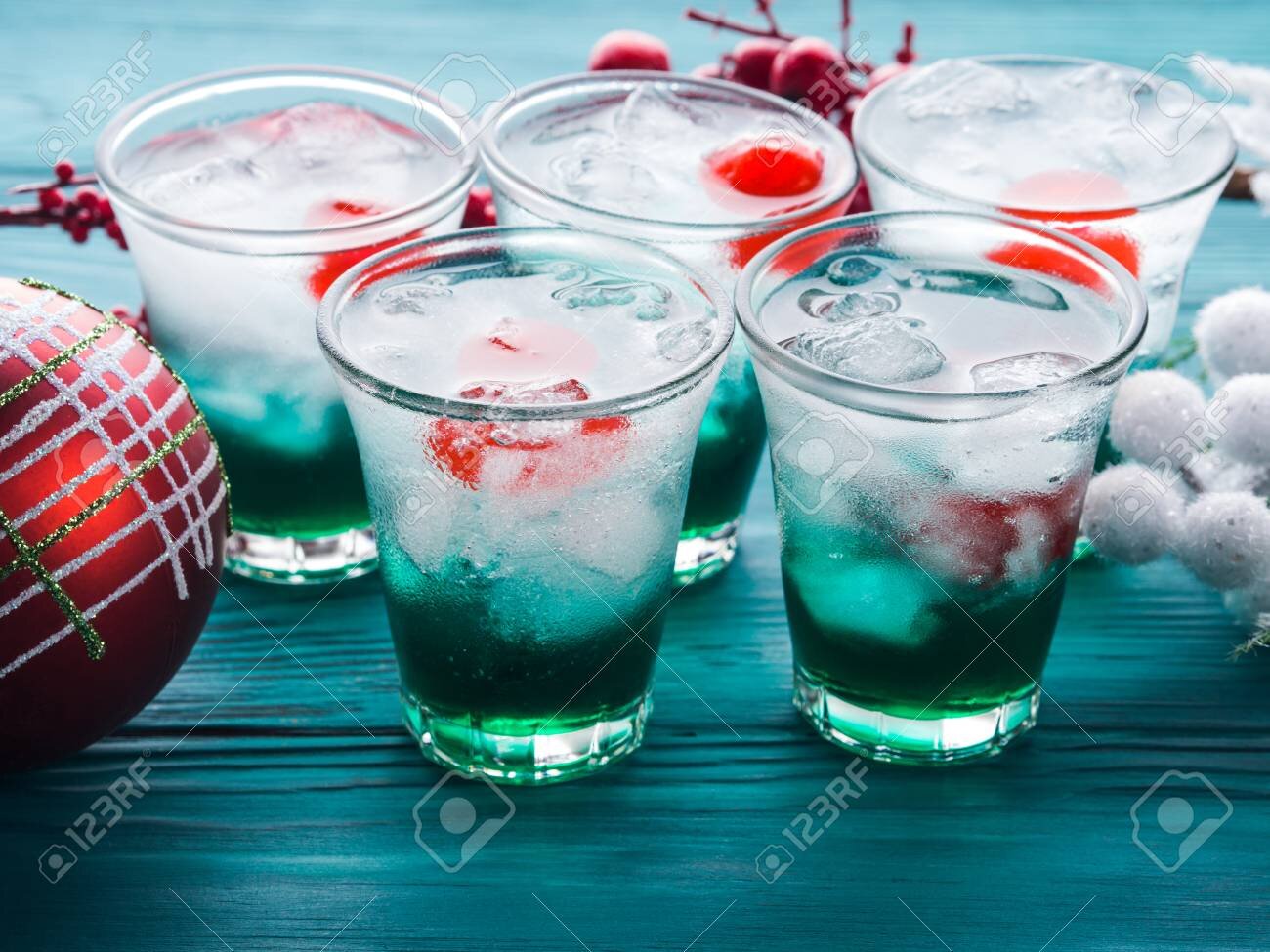 89965692-christmas-holiday-party-green-alcohol-drinks-with-cherry-festive-aperitif-shots-and-ornaments-on-woo.jpg