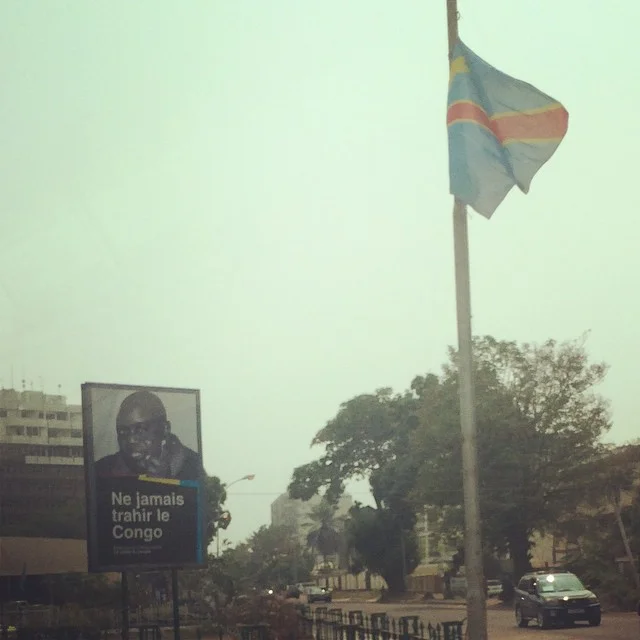 A billboard, that translates to "Never Betray Congo" in English.