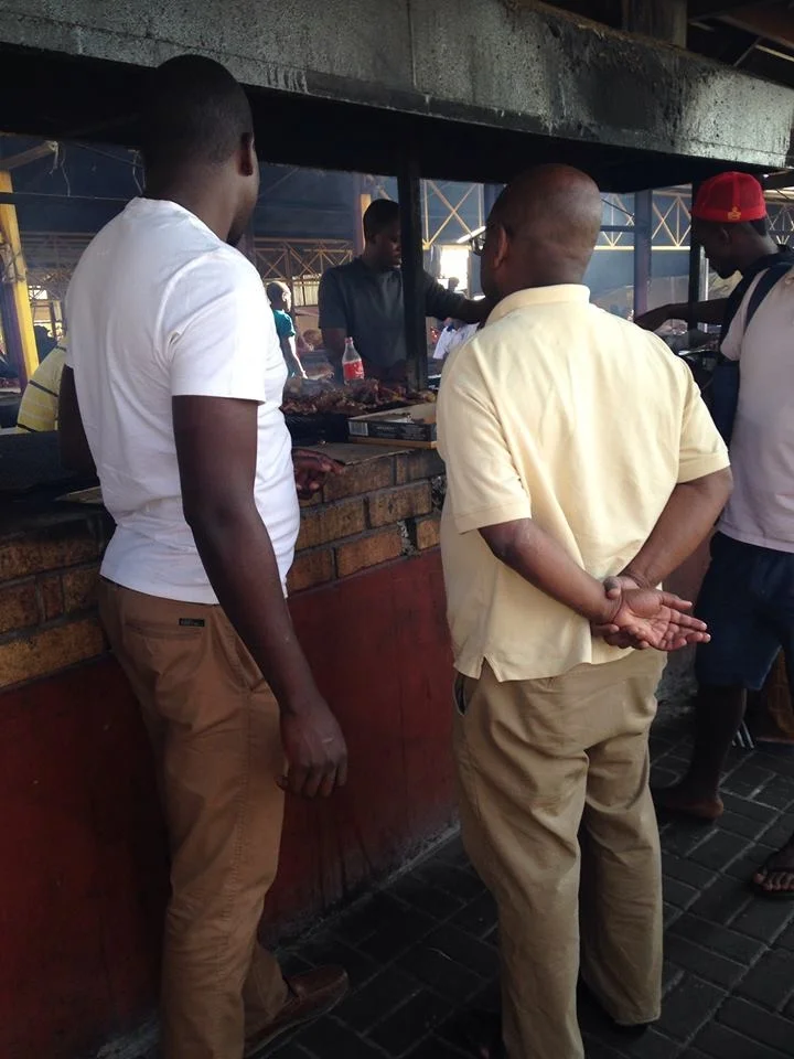 My husband and father tasting out meet at a Namibian open market.