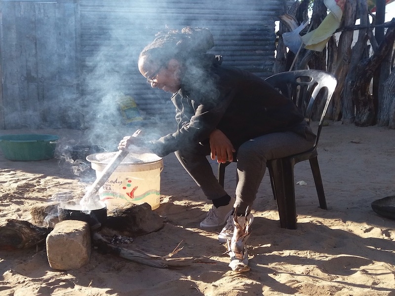 The author cooking over a fire in a northern Namibian village.