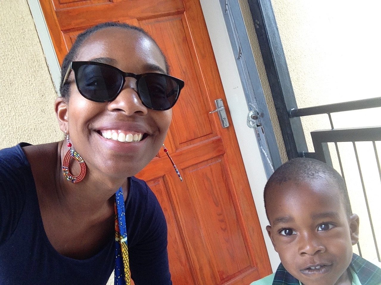 The author donning Warby Parker sunglasses with her son.