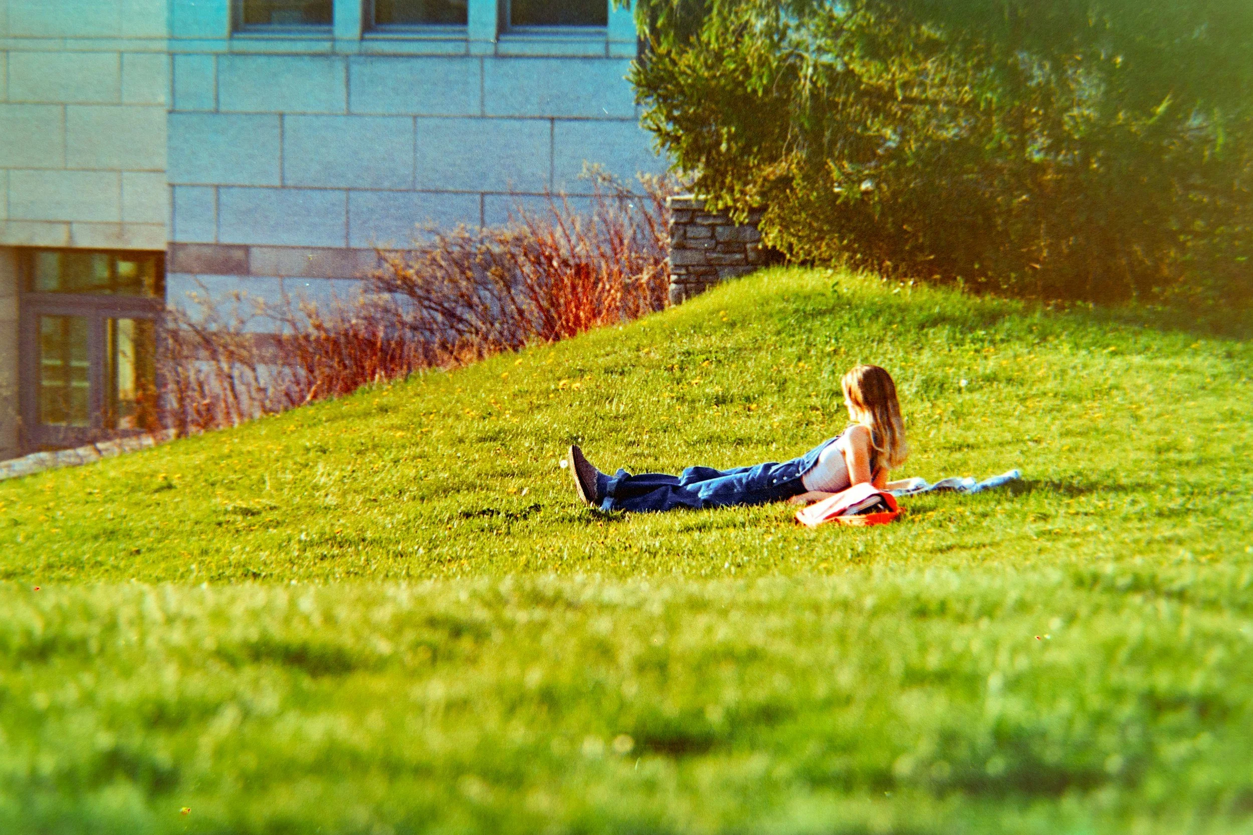 Person sitting quietly near a sunny window — use alt text: "Person sitting quietly in a sunny space, illustrating mindfulness and attention