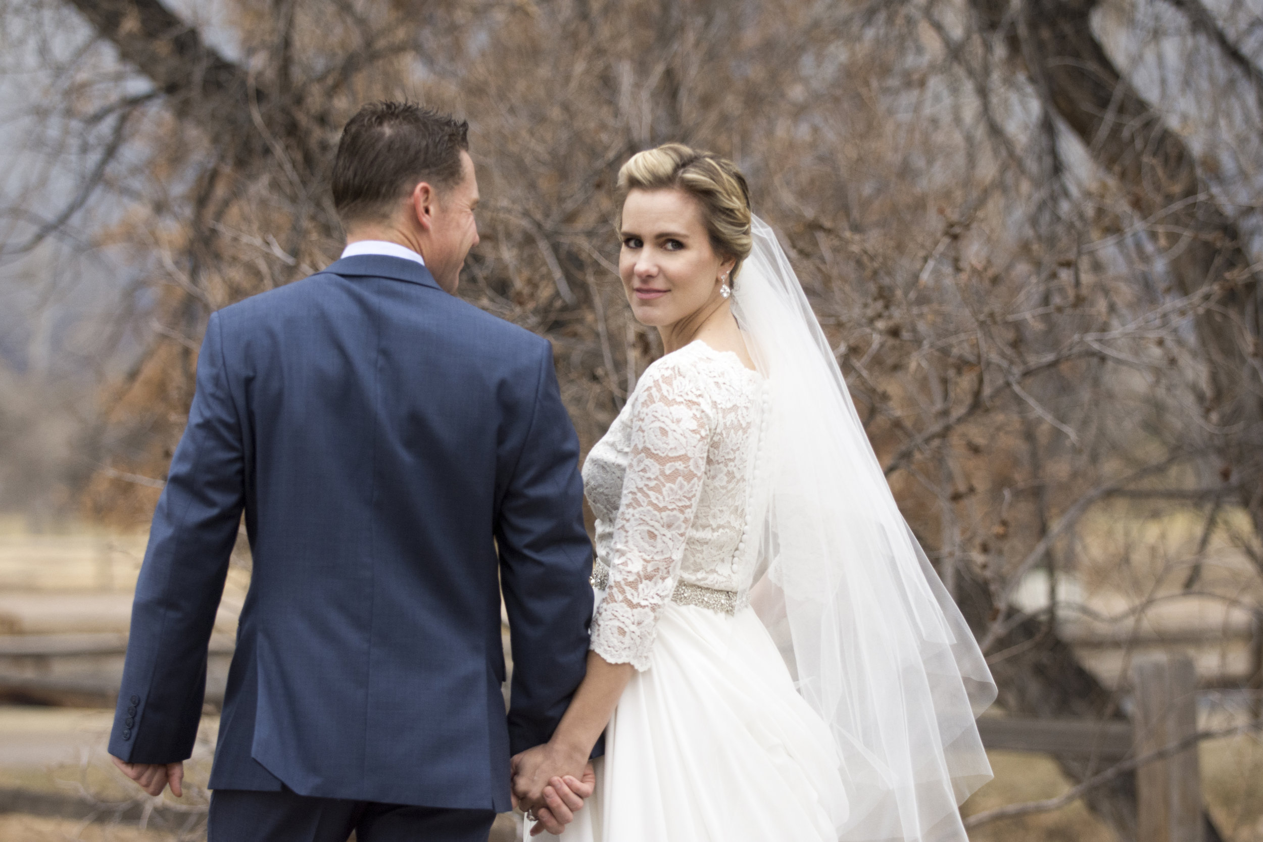 Bride and groom hand in hand | Mary and Brad's Outdoor wedding photography at Hudson Gardens | Colorado Springs, Colorado | Farm Wedding Photographer | Apollo Fields Wedding Photojournalism