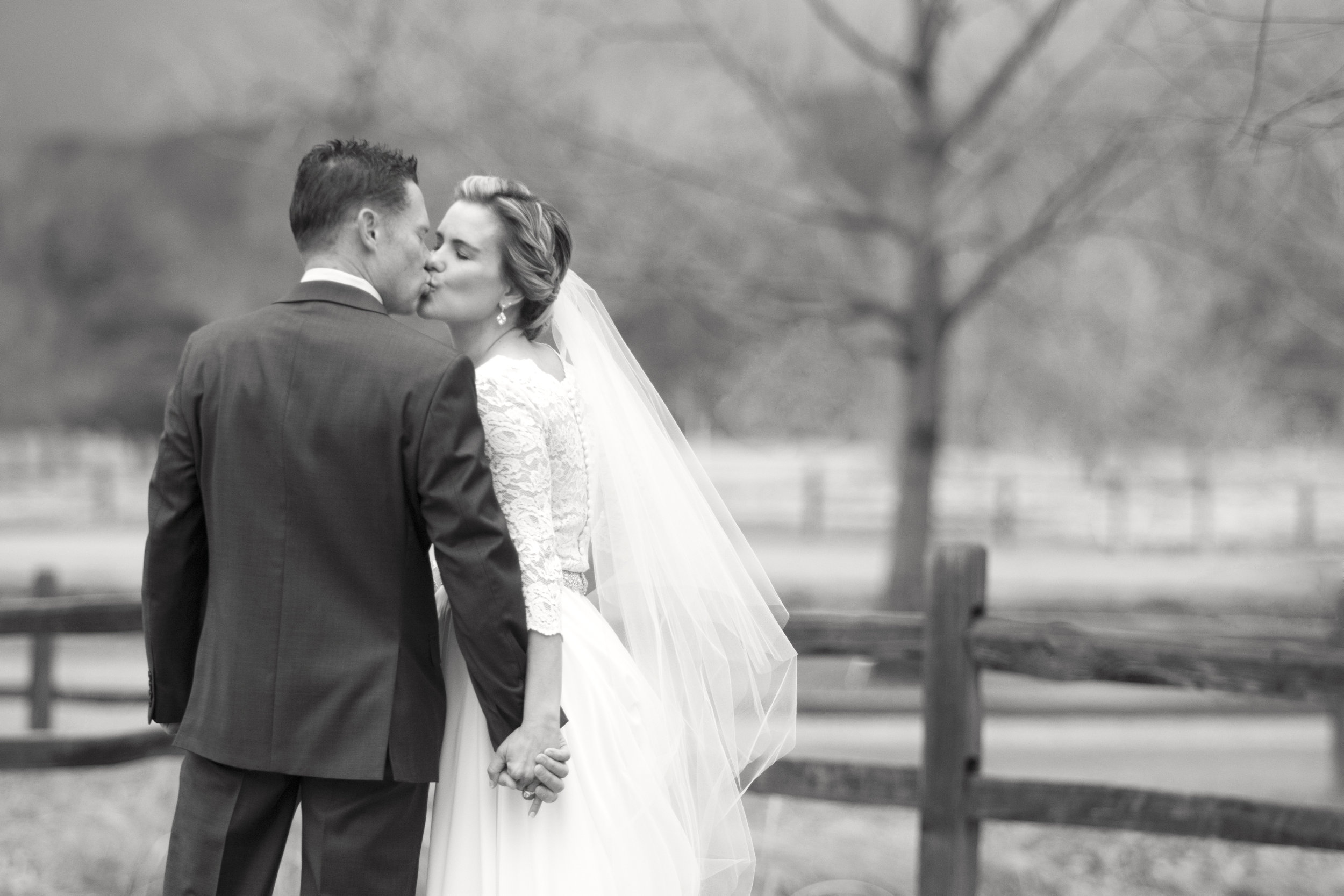 Bride and groom black and white kissing | Mary and Brad's outdoor wedding photography at Hudson Gardens | Colorado Springs, Colorado | Farm Wedding Photographer | Apollo Fields Wedding Photojournalism