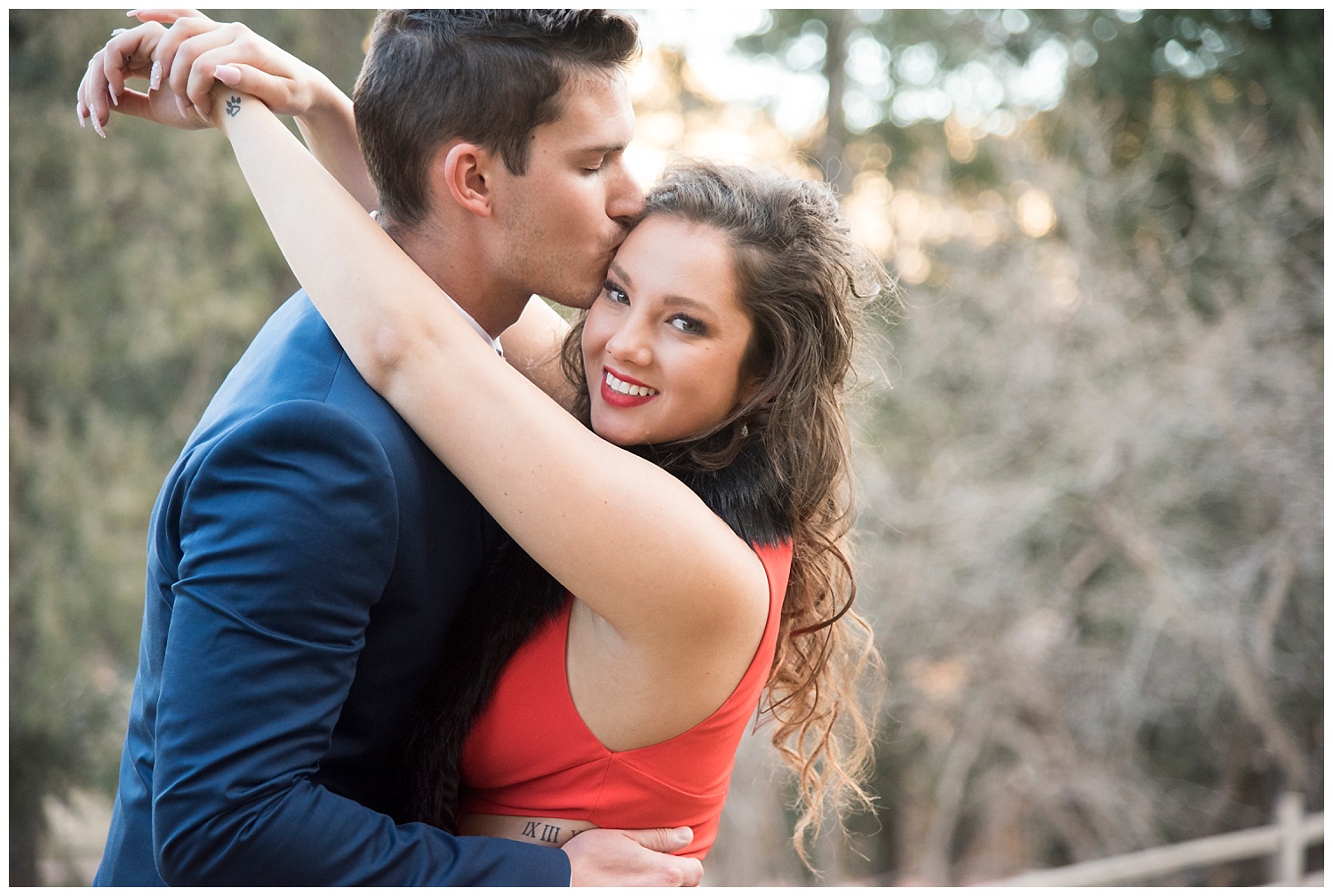 Man Kissing Woman While She Looks at Camera | Nicholas and Eden's Surprise Proposal at Glen Eyrie Castle | Colorado Springs | Farm Wedding Photographer | Apollo Fields Wedding Photojournalism